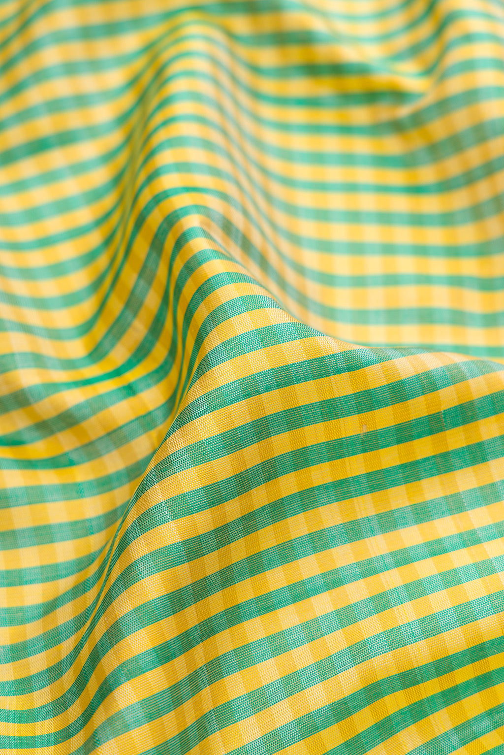 Close up of Multi Color Gadwal Silk Saree with Checked design on the body and Temple Border.  displaying folds