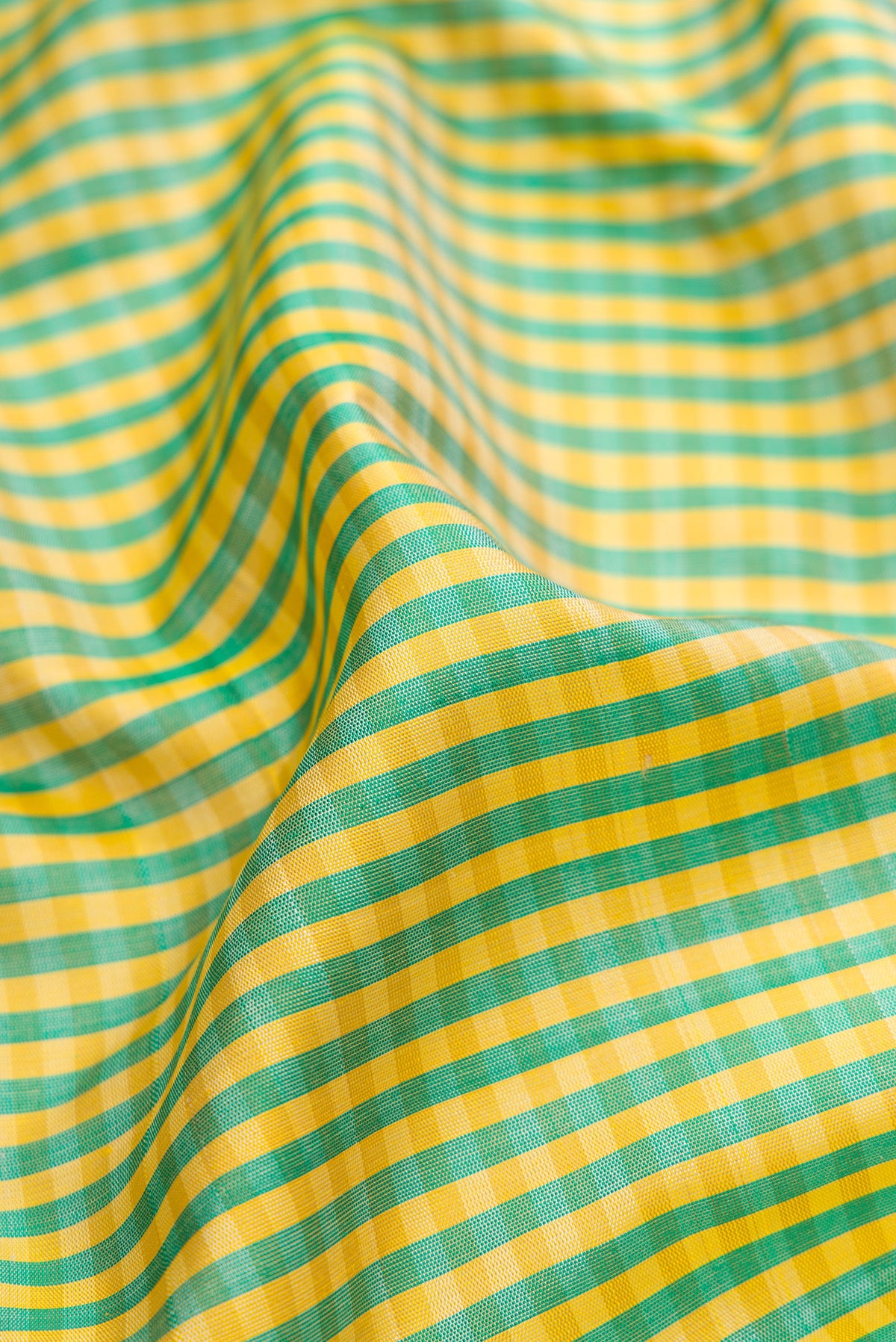Close up of Multi Color Gadwal Silk Saree with Checked design on the body and Temple Border.  displaying folds