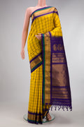 Yellow Gadwal Silk Saree with Checked design on the body and Zari Border.  displayed on a mannequin