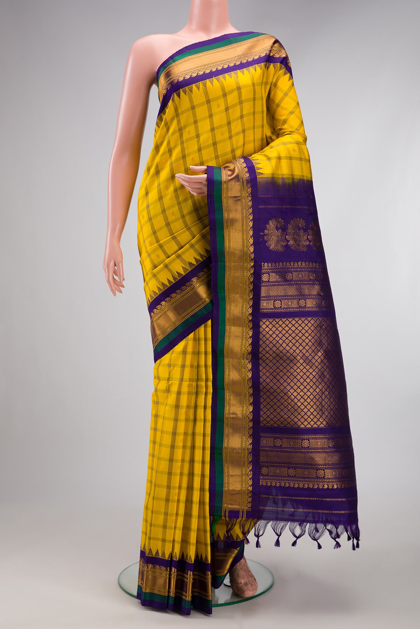 Yellow Gadwal Silk Saree with Checked design on the body and Zari Border.  displayed on a mannequin