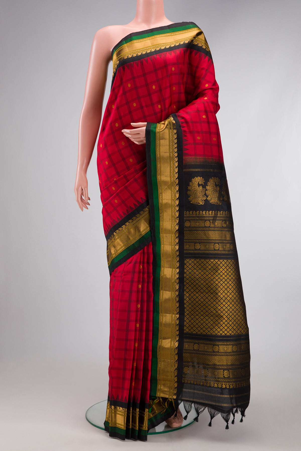 Red Gadwal Silk Saree with Checked design on the body and Zari Border.  displayed on a mannequin