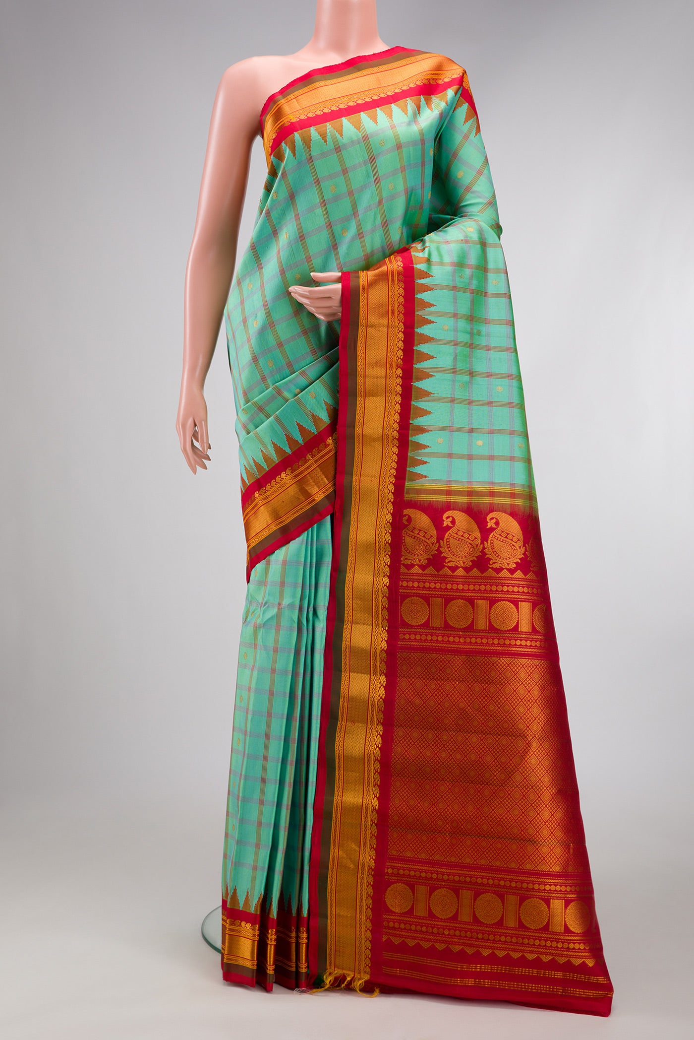 Sea Green Gadwal Silk Saree with Checked design on the body and Zari Border.  displayed on a mannequin