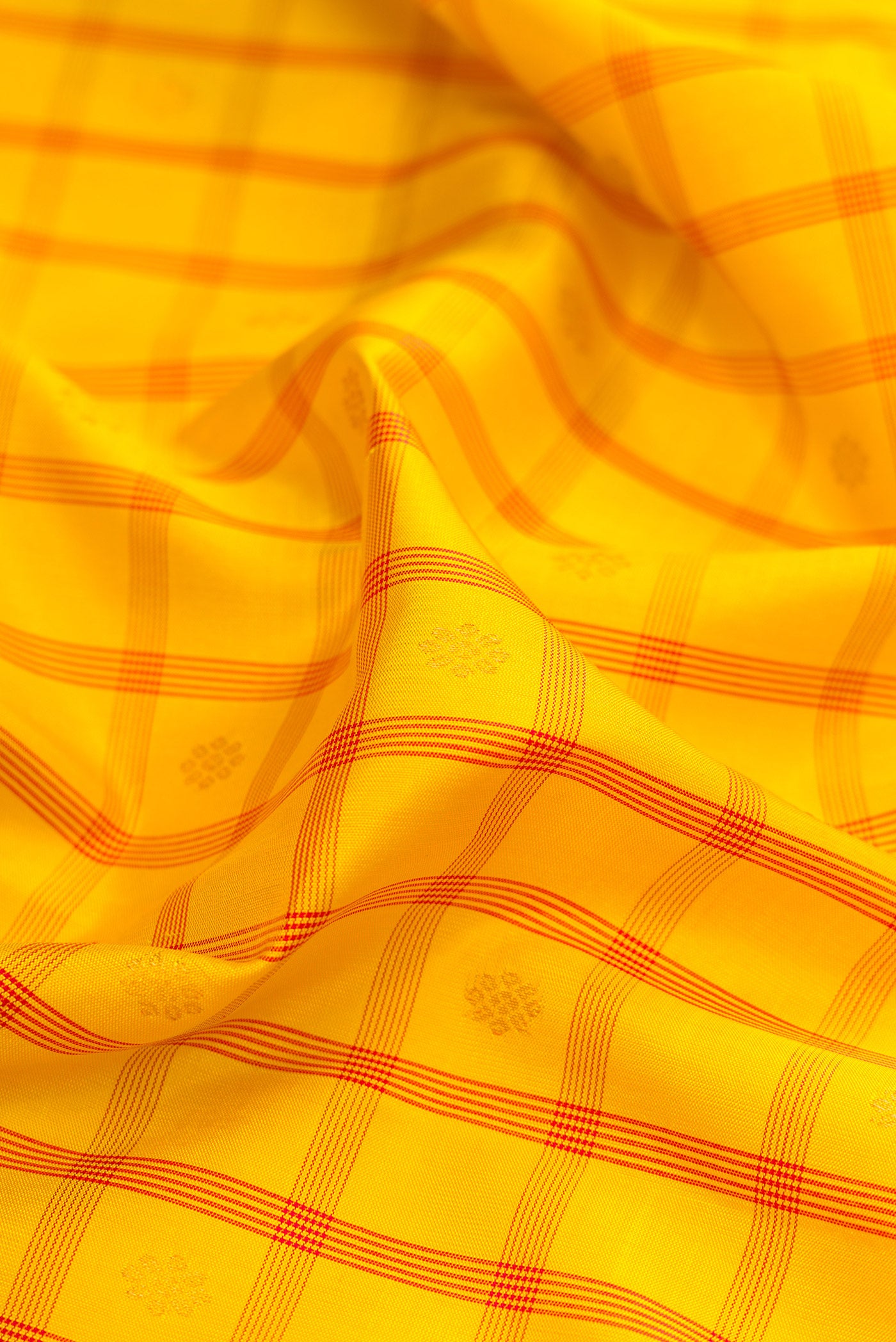 Close up of Yellow Gadwal Silk Saree with Checked design on the body and Zari Border.  displaying folds
