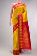 Yellow Gadwal Silk Saree with Checked design on the body and Zari Border.  displayed on a mannequin