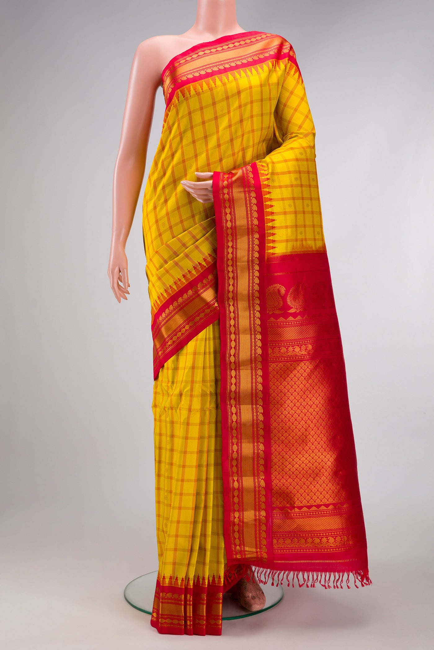 Yellow Gadwal Silk Saree with Checked design on the body and Zari Border.  displayed on a mannequin