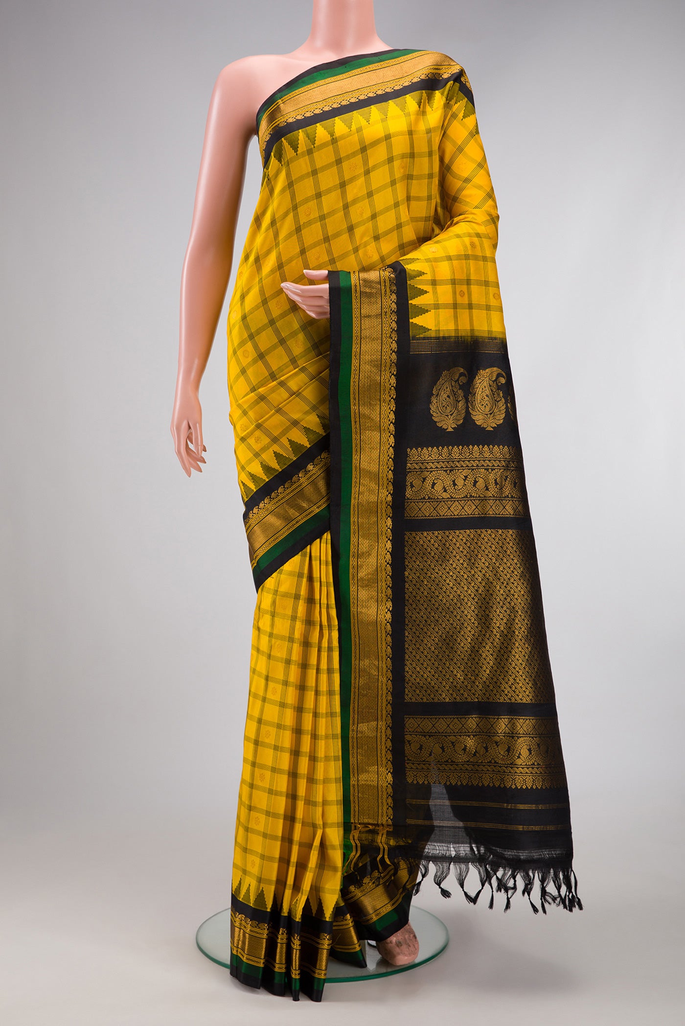 Yellow Gadwal Silk Saree with Checked design on the body and Zari Border.  displayed on a mannequin
