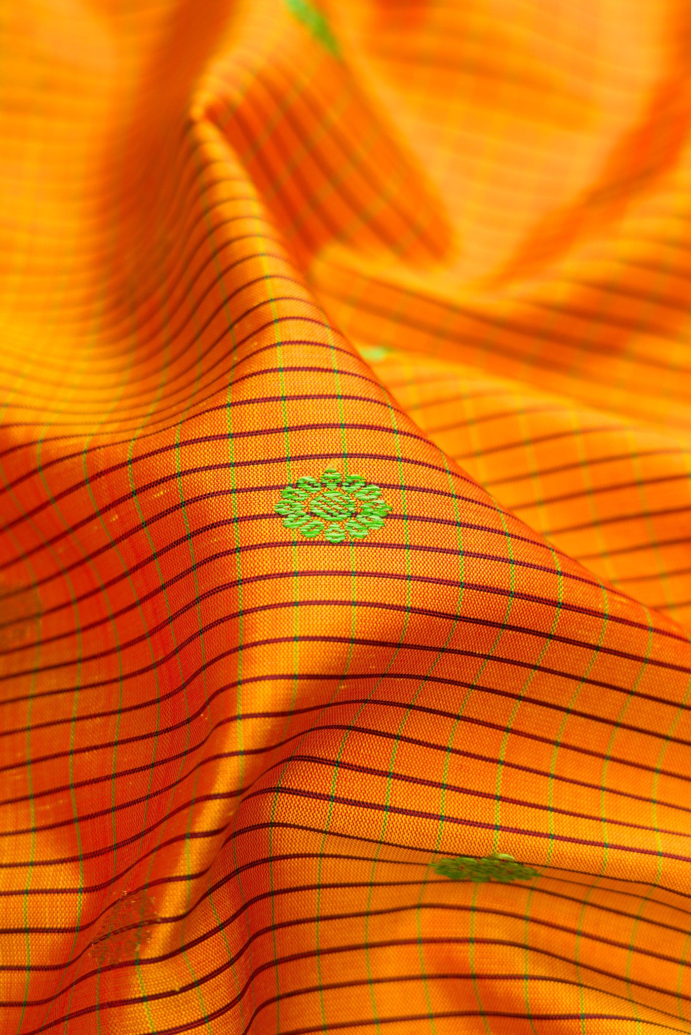 Close up of Mustard Gadwal Silk Saree with Checked design on the body and Temple Border.  displaying folds