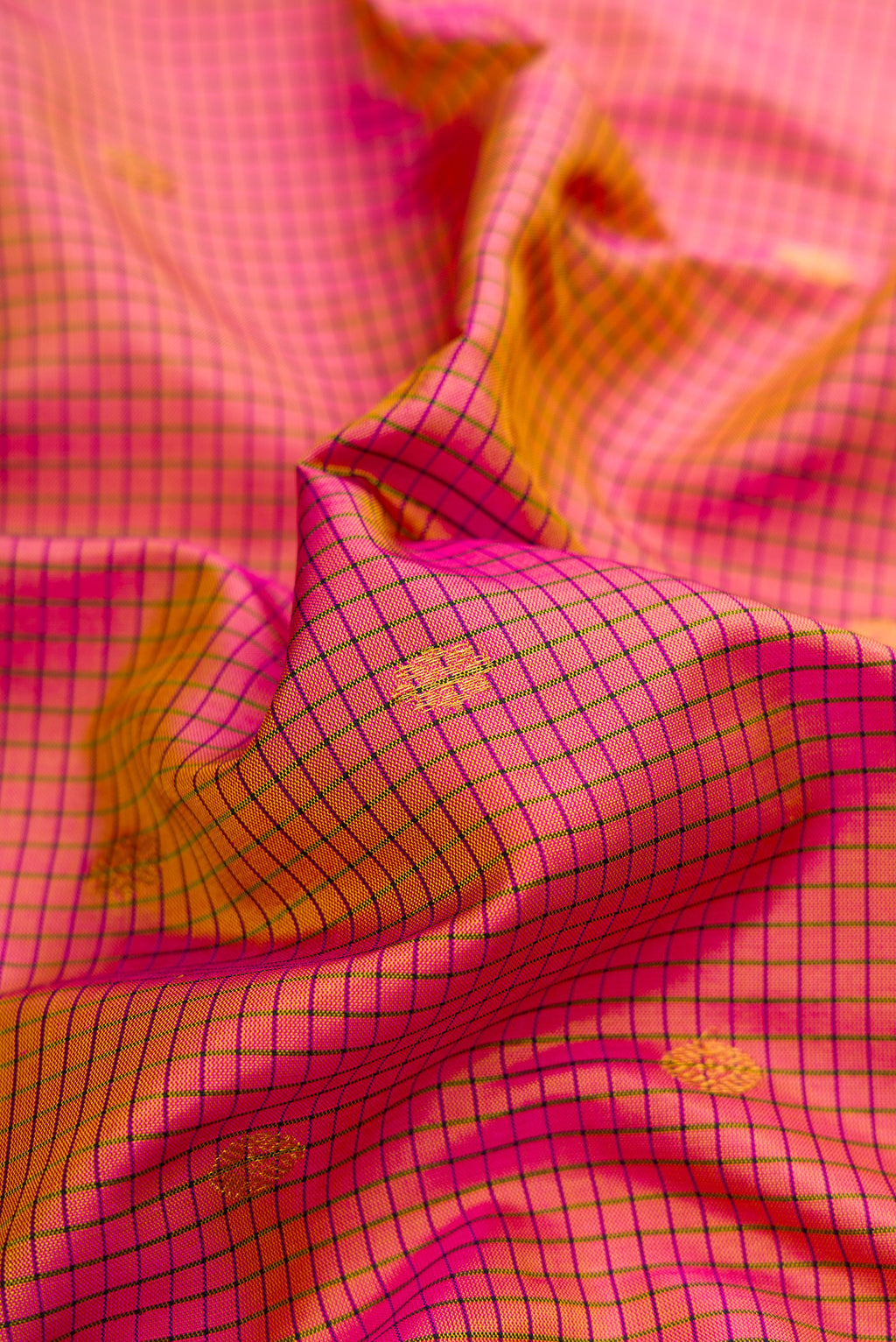 Close up of Pink Dual Tone Gadwal Silk Saree with Checked design on the body and Temple Border.  displaying folds