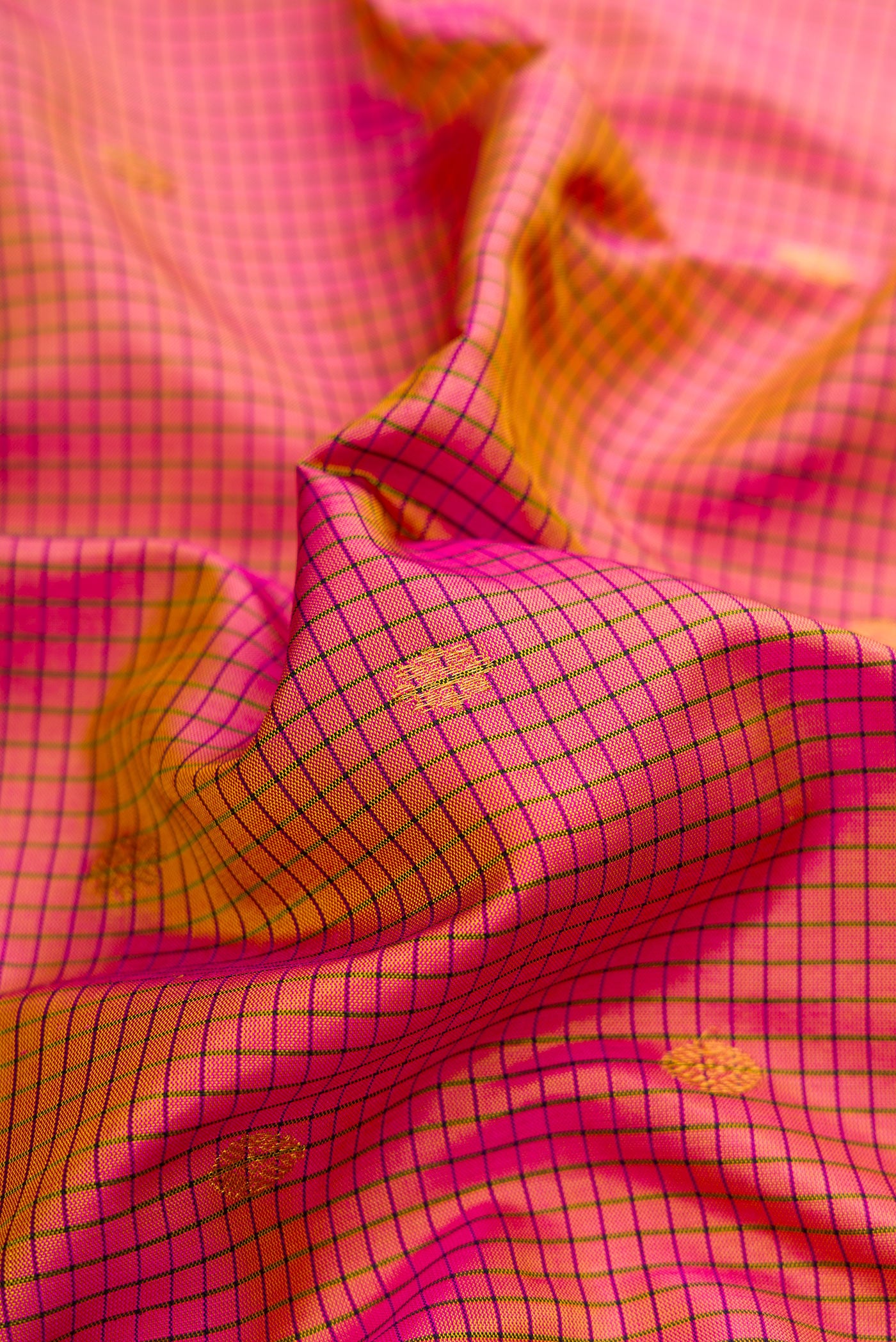 Close up of Pink Dual Tone Gadwal Silk Saree with Checked design on the body and Temple Border.  displaying folds