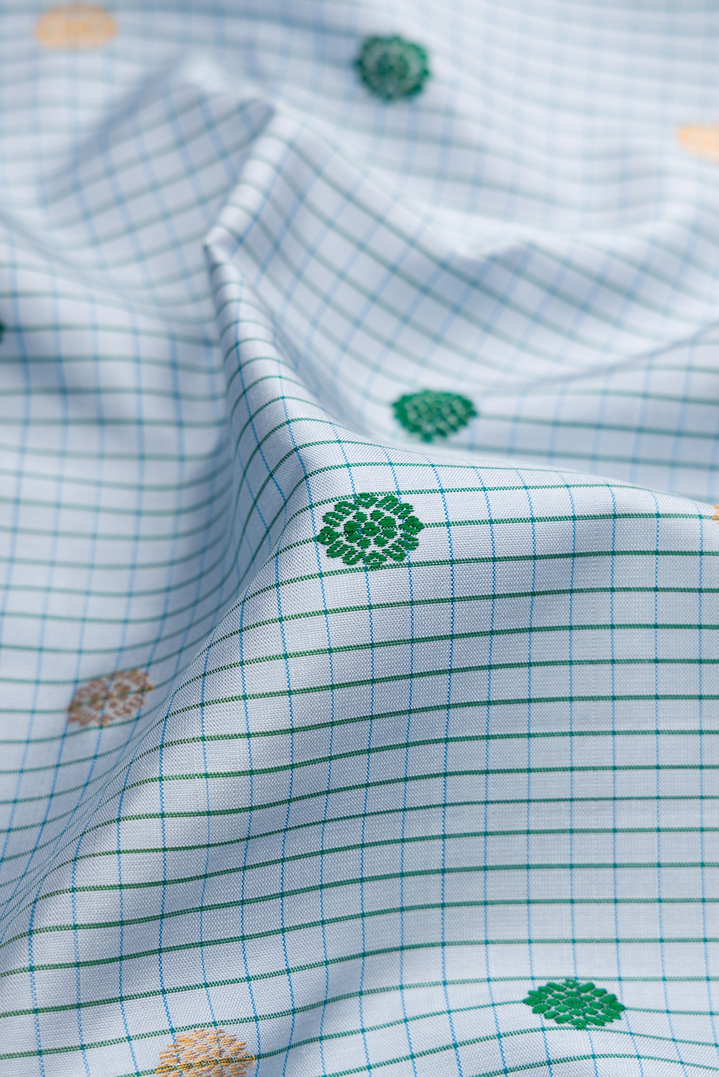 Close up of Maya Blue Gadwal Silk Saree with Checked design on the body and Temple Border.  displaying folds