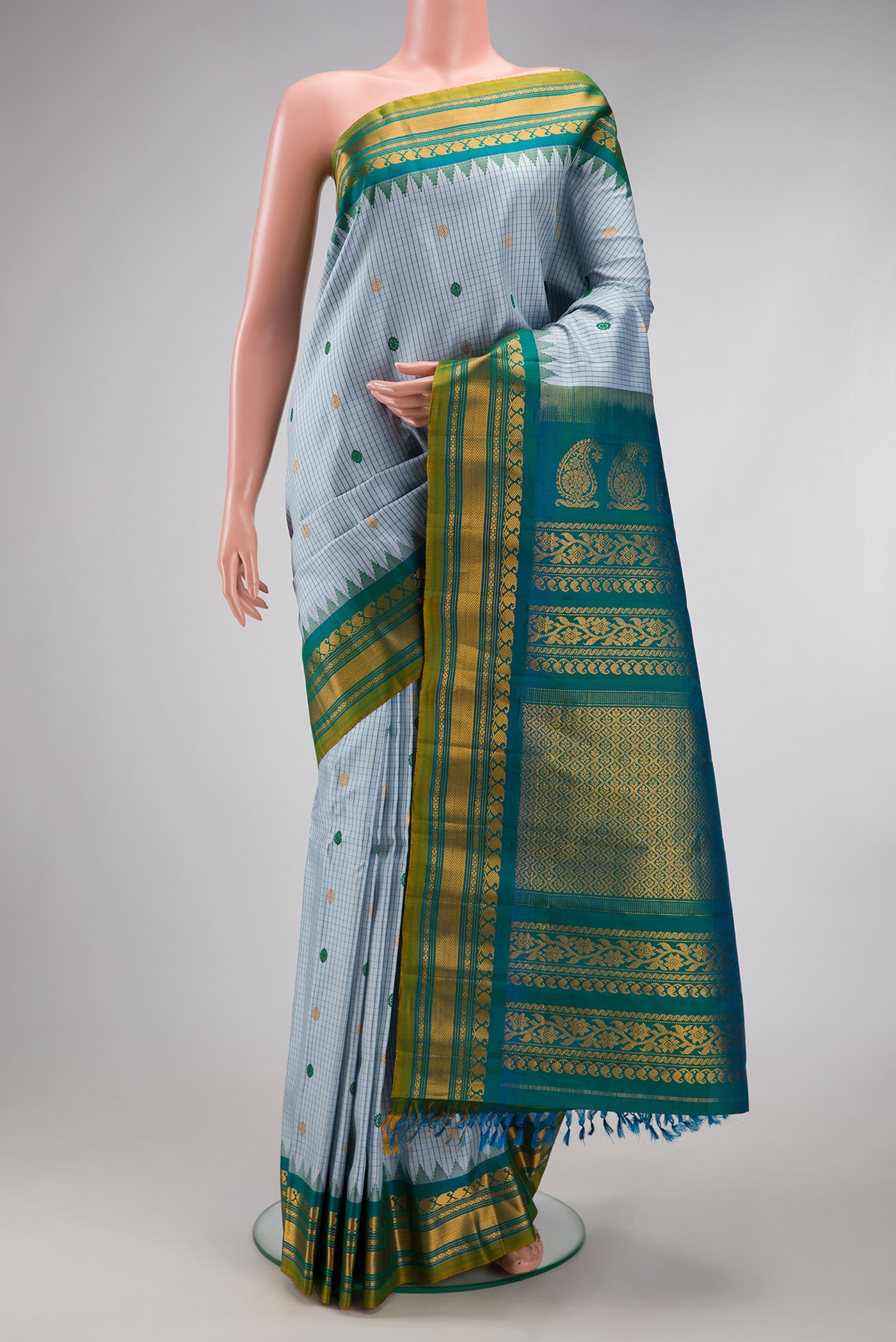 Maya Blue Gadwal Silk Saree with Checked design on the body and Temple Border.  displayed on a mannequin