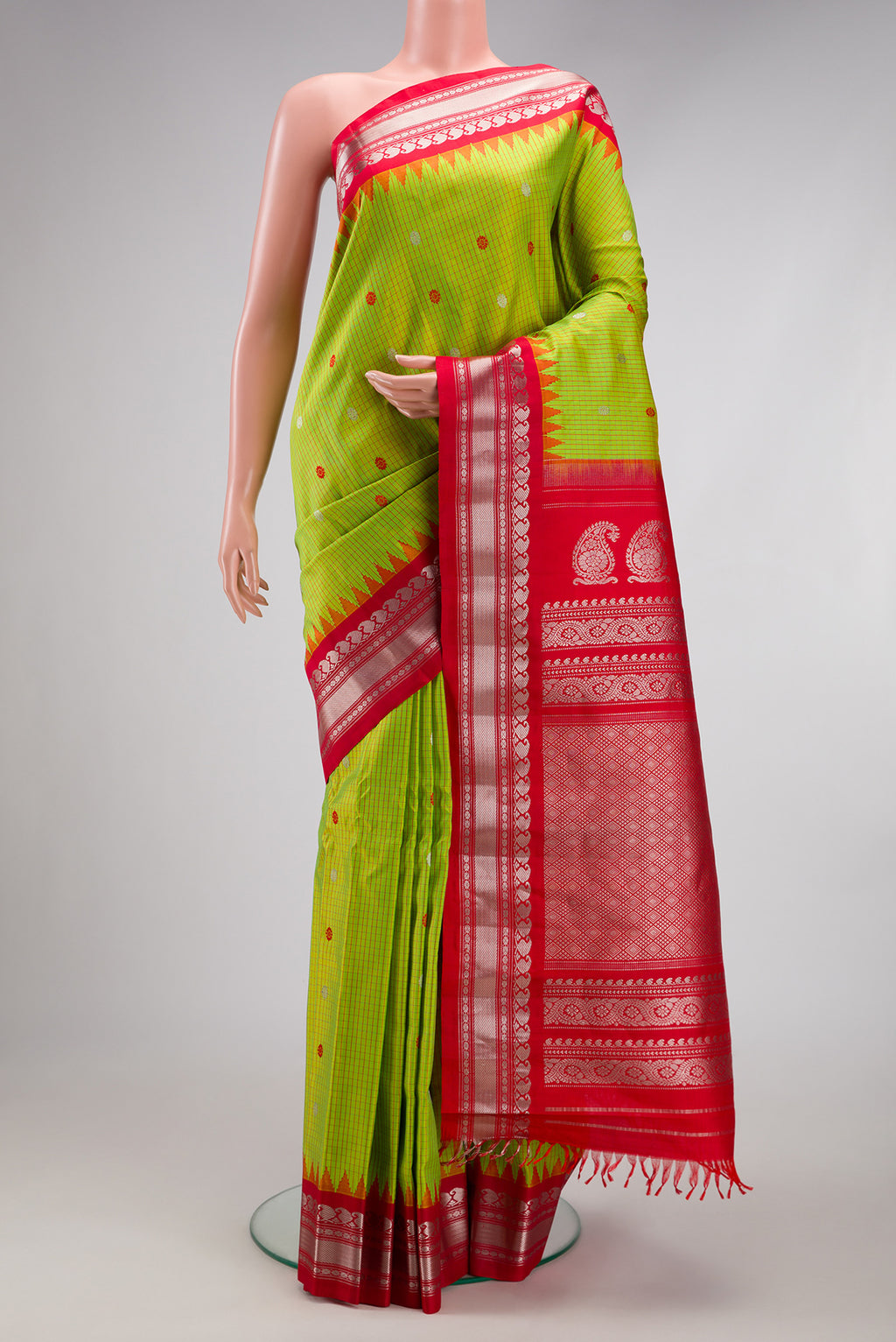 Parrot Green Gadwal Silk Saree with Checked design on the body and Temple Border.  displayed on a mannequin