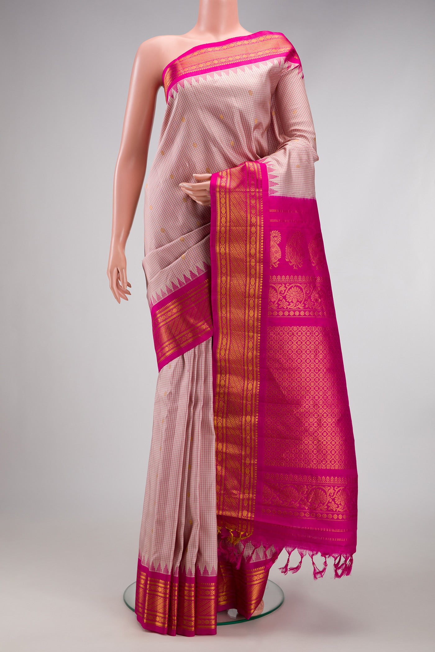 Beige Gadwal Silk Saree with Checked design on the body and Temple Border.  displayed on a mannequin