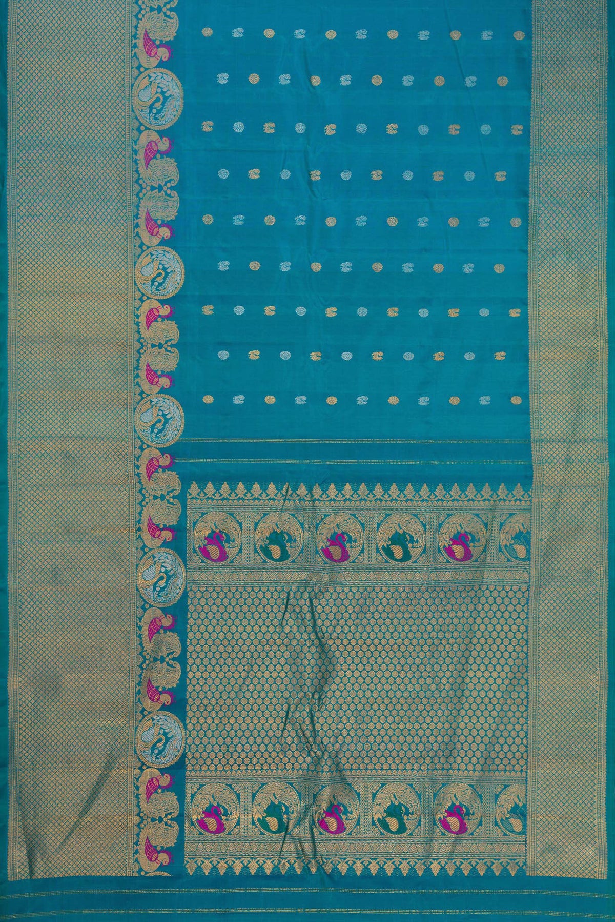 Flat view of Peacock Blue Gadwal Silk Saree with Zari Butta on the body and Fancy Border. 