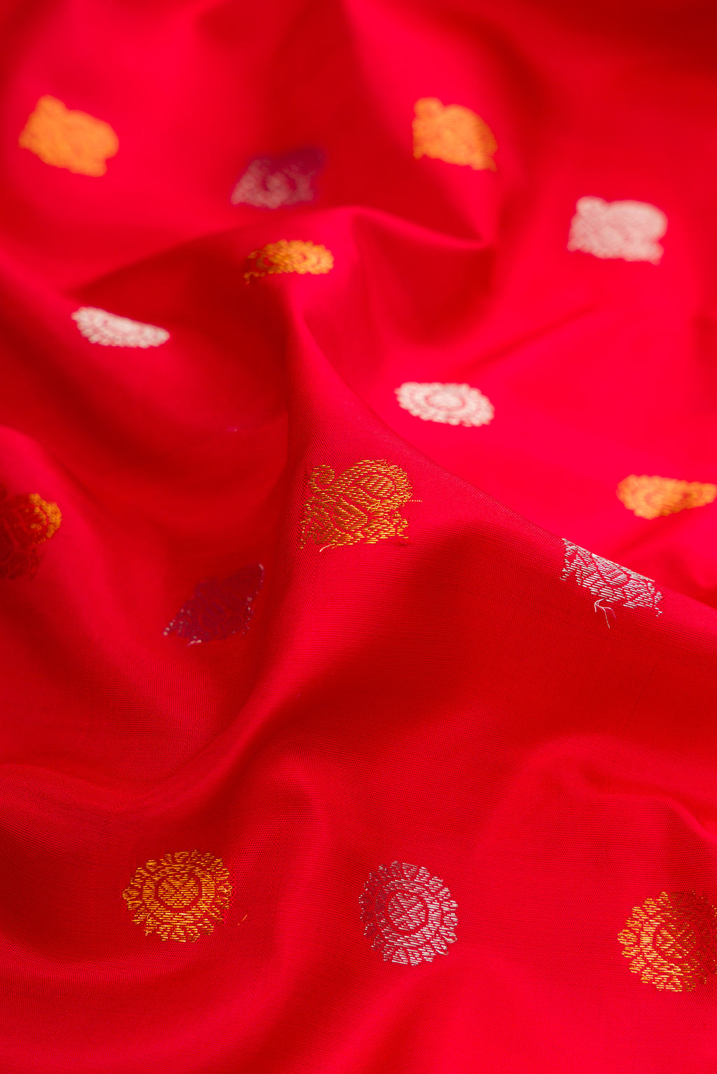 Close up of Red Gadwal Silk Saree with Zari Butta on the body and Zari Border.  displaying folds