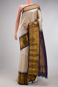 Cream Gadwal Silk Saree with Zari Butta on the body and Zari Border.  displayed on a mannequin