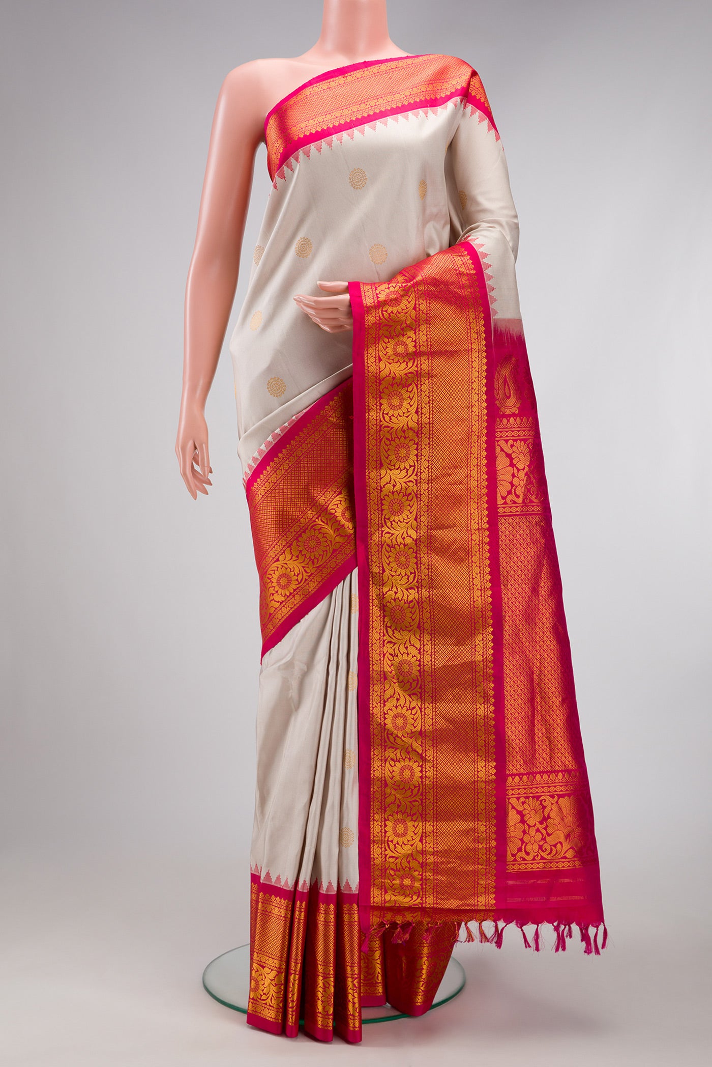 Cream Gadwal Silk Saree with Zari Butta on the body and Zari Border.  displayed on a mannequin