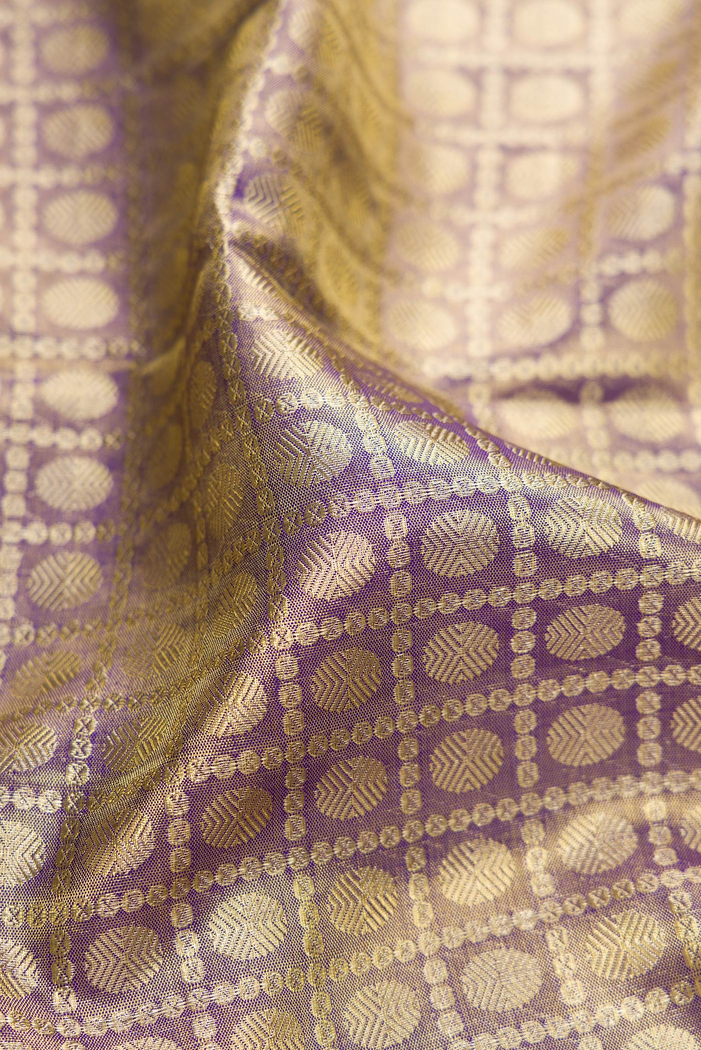Close up of Purple Dual Tone Kanchipuram Tissue Silk Saree with Zari Brocade on the body and Zari Border.  displaying folds