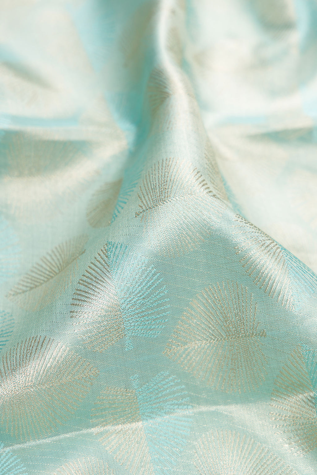 Close up of Sky Blue Dual Tone Kanjivaram Tissue Silk Saree with Zari Brocade on the body and Zari Border.  displaying folds