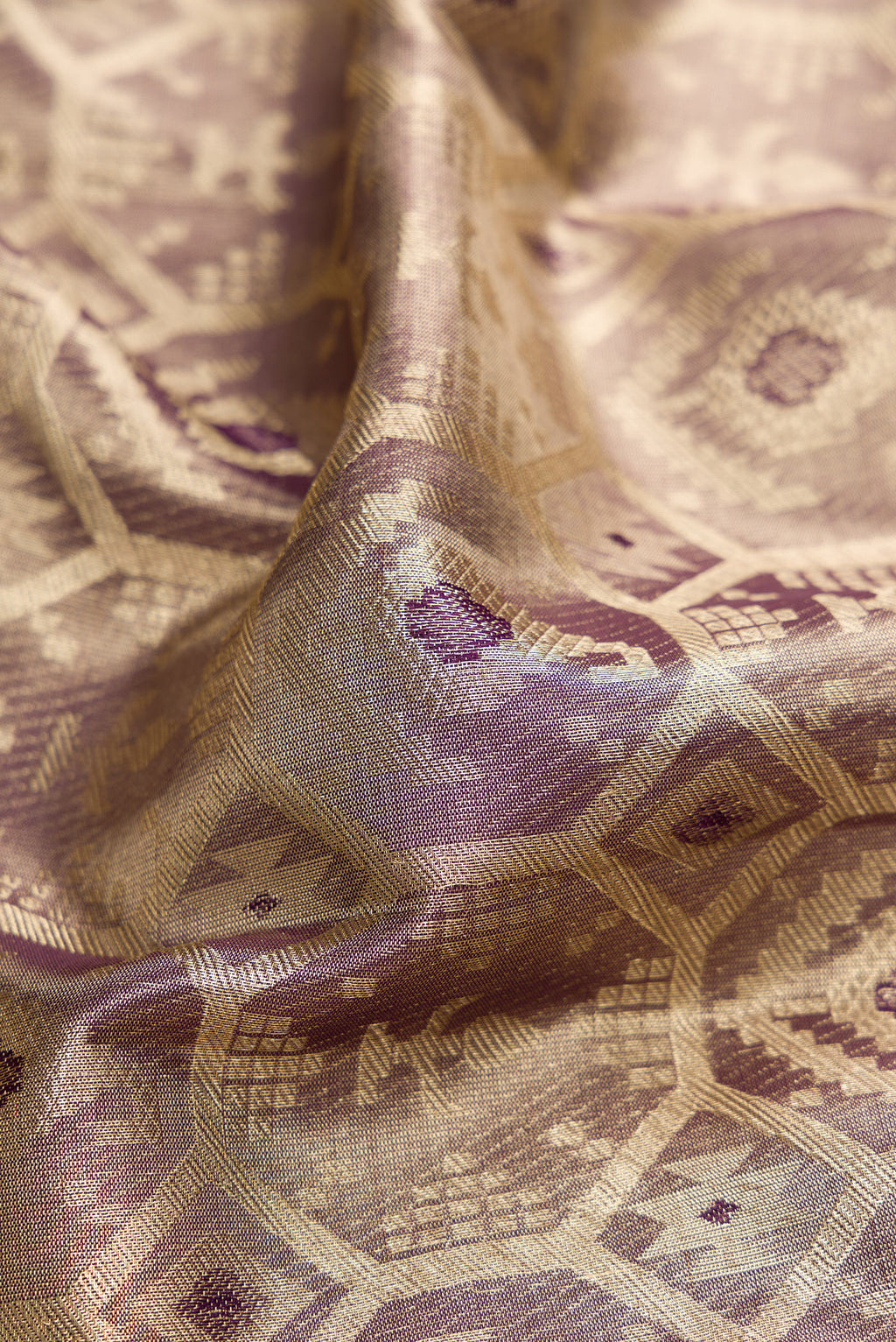 Close up of Purple Dual Tone Kanjivaram Tissue Silk Saree with Zari Brocade on the body and Zari Border.  displaying folds