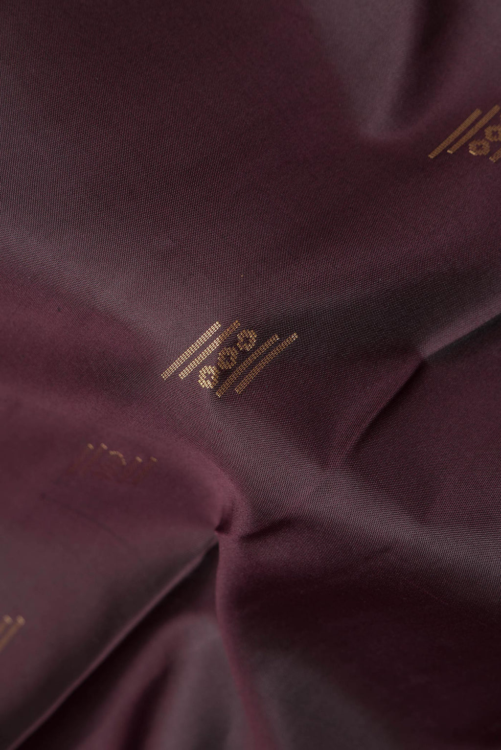 Close up of Pure Silk Coffee Brown Soft Saree with Zari Butta on the body and Zari Border.  displaying folds