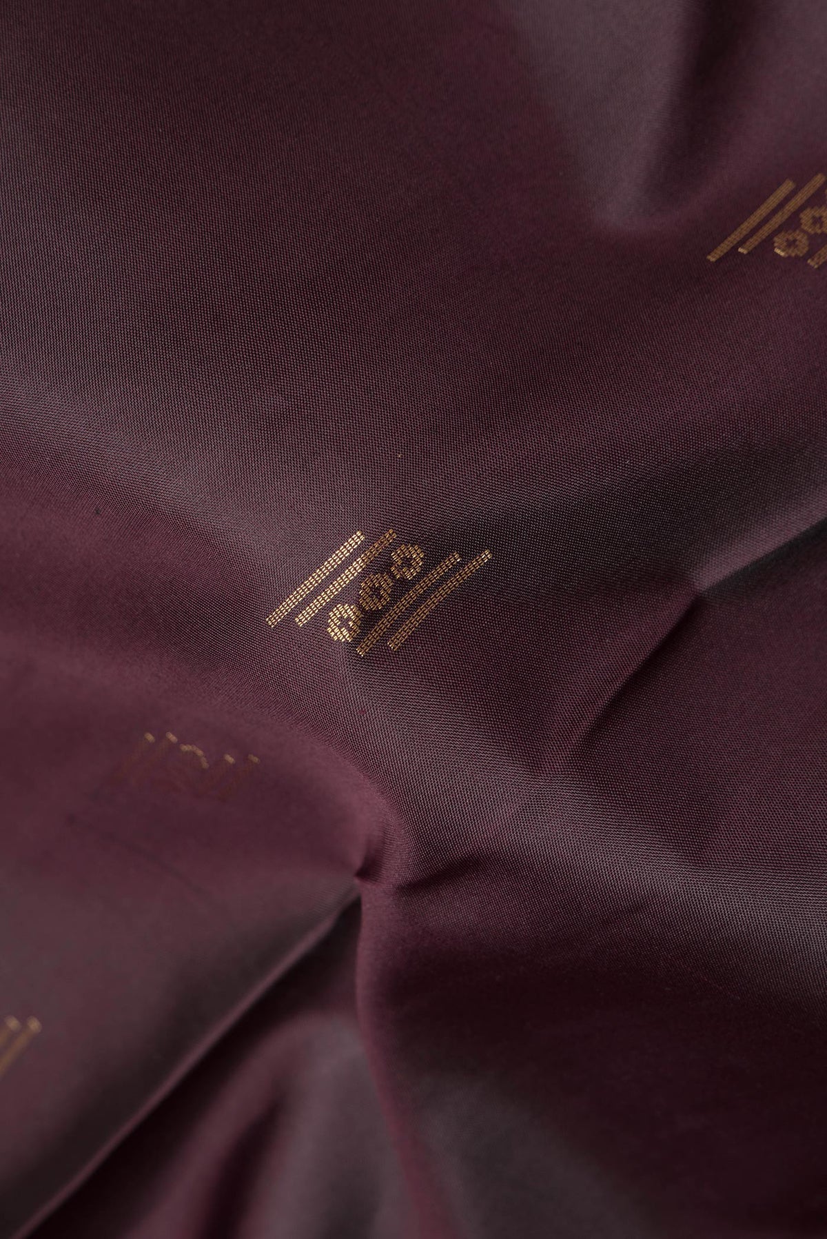 Close up of Pure Silk Coffee Brown Soft Saree with Zari Butta on the body and Zari Border.  displaying folds