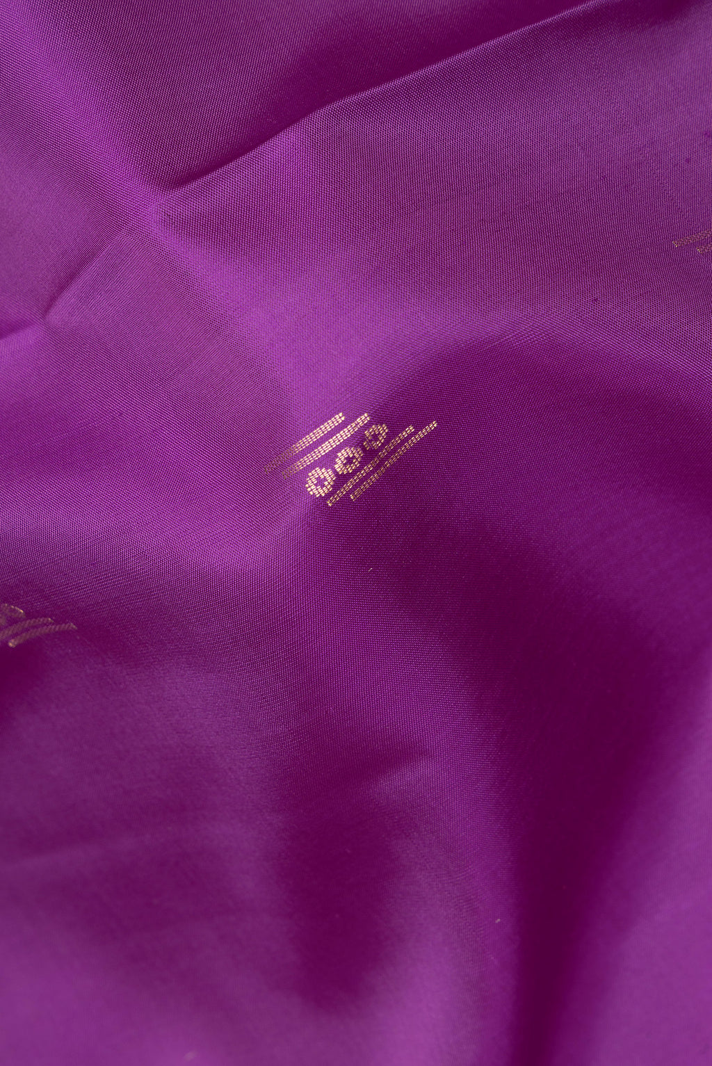 Close up of Pure Silk Purple Soft Saree with Zari Butta on the body and Zari Border.  displaying folds