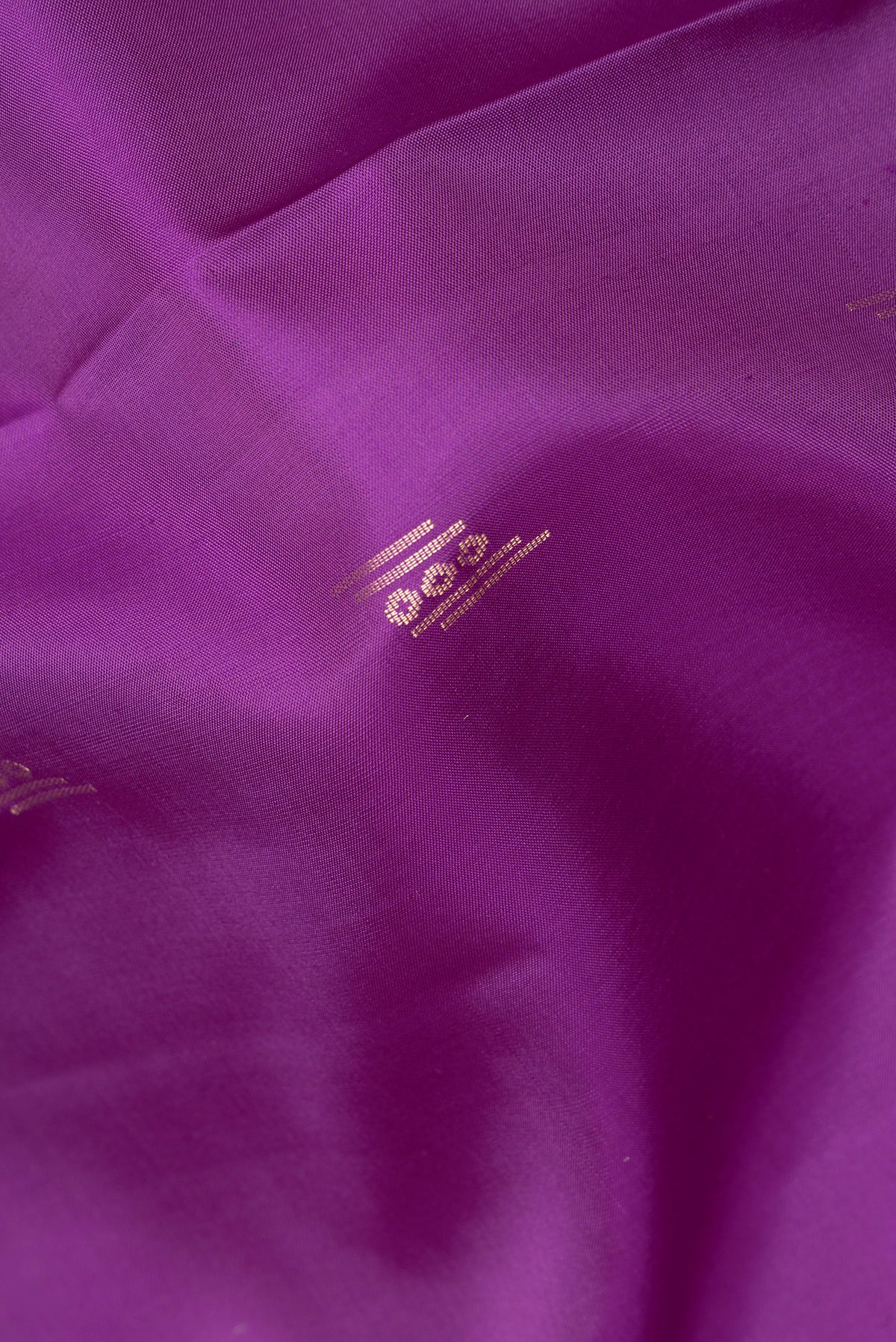 Close up of Pure Silk Purple Soft Saree with Zari Butta on the body and Zari Border.  displaying folds