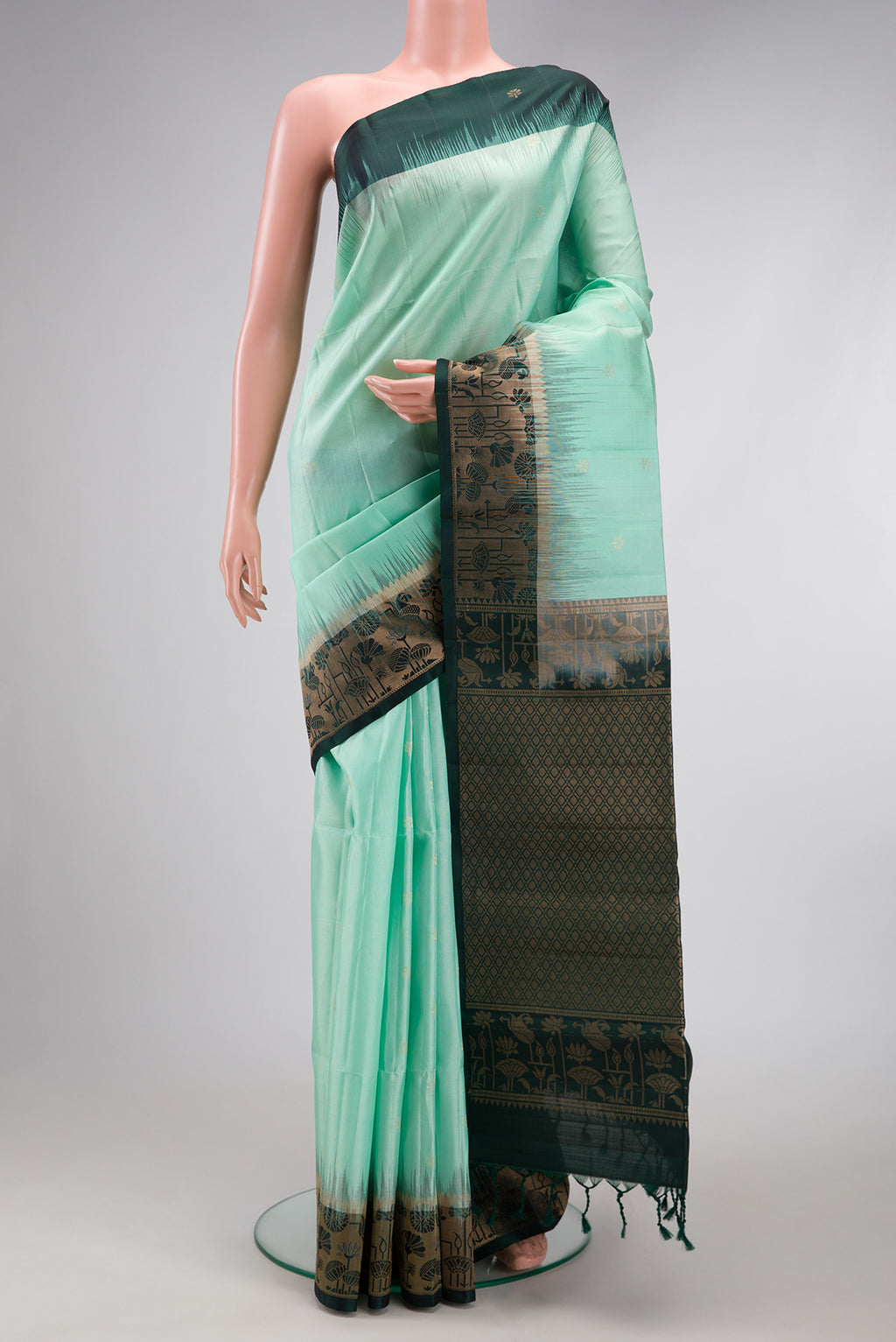 Sea Green Soft Silk Saree with Zari Butta on the body and Fancy Border.  displayed on a mannequin