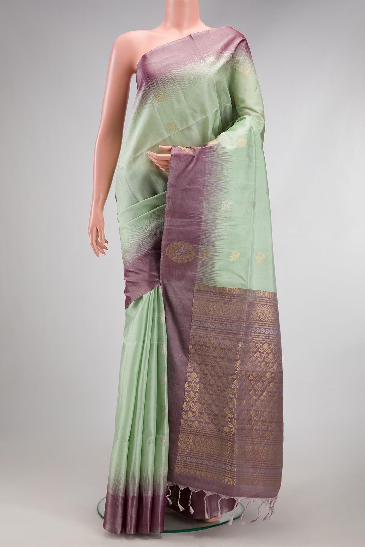 Pista Green Soft Silk Saree with Zari Butta on the body and Fancy Border.  displayed on a mannequin