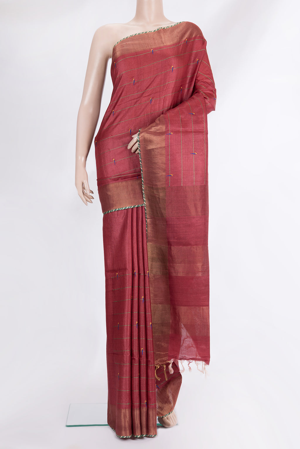 Pure Silk Rust Tussar Saree with Embroidered on the body and Zari Border.  displayed on a mannequin