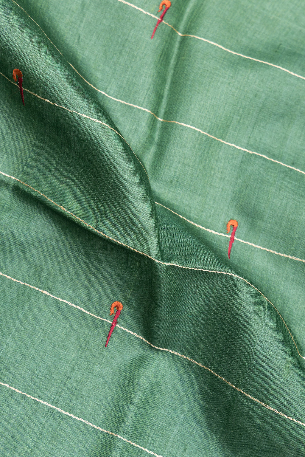 Close up of Green Tussar Saree with Stripes on the body and Zari Border.  displaying folds