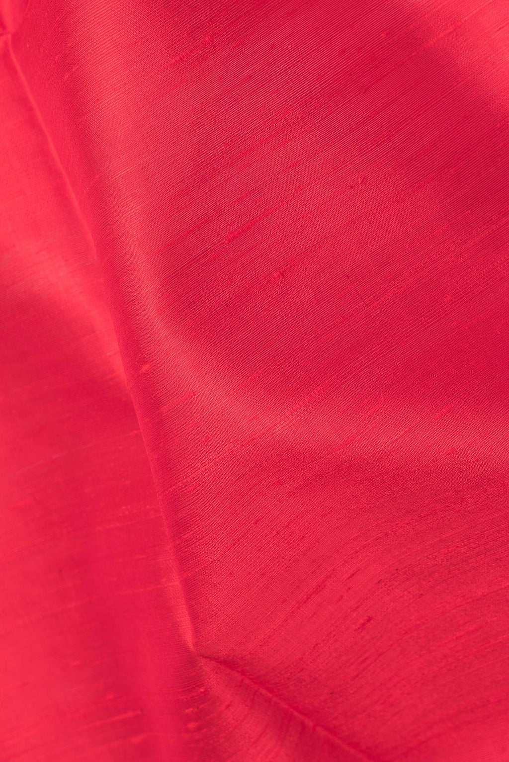 Close up of Pure Silk Red Dual Tone Raw Saree with Plain Body and Zari Border.  displaying folds