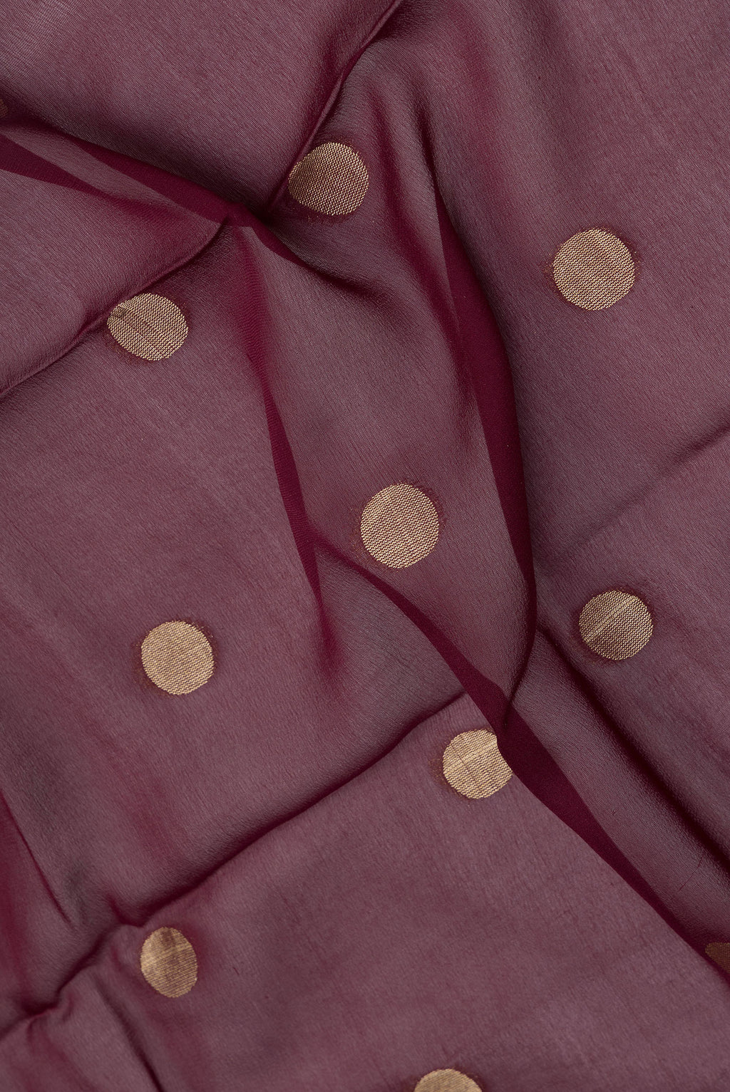 Close up of Maroon Dual Tone Georgette Saree with Zari Butta on the body and Zari Border.  displaying folds
