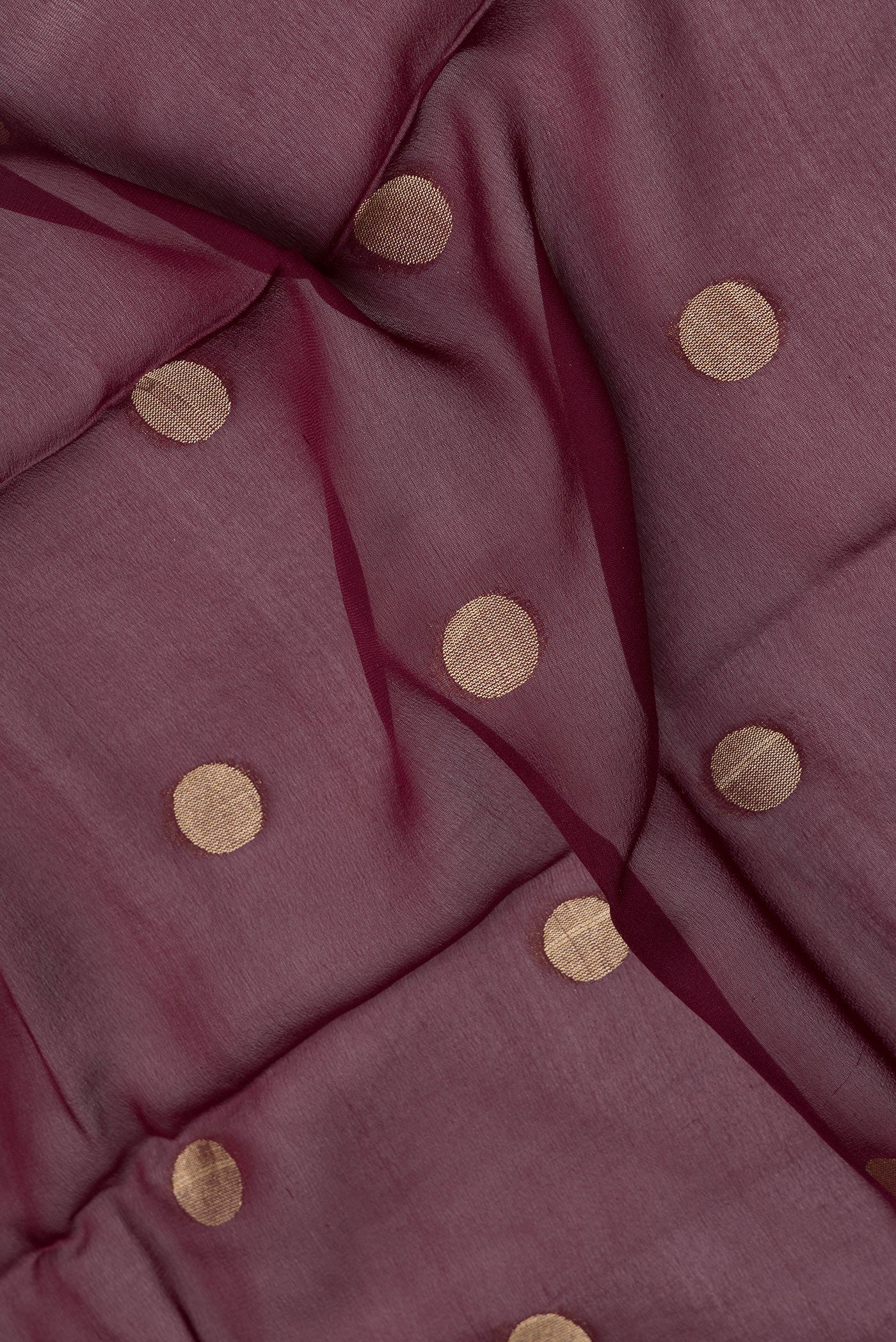 Close up of Maroon Dual Tone Georgette Saree with Zari Butta on the body and Zari Border.  displaying folds