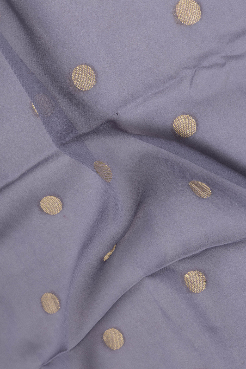Close up of Grey Mysore Georgette Saree with Zari Butta on the body and Zari Border.  displaying folds