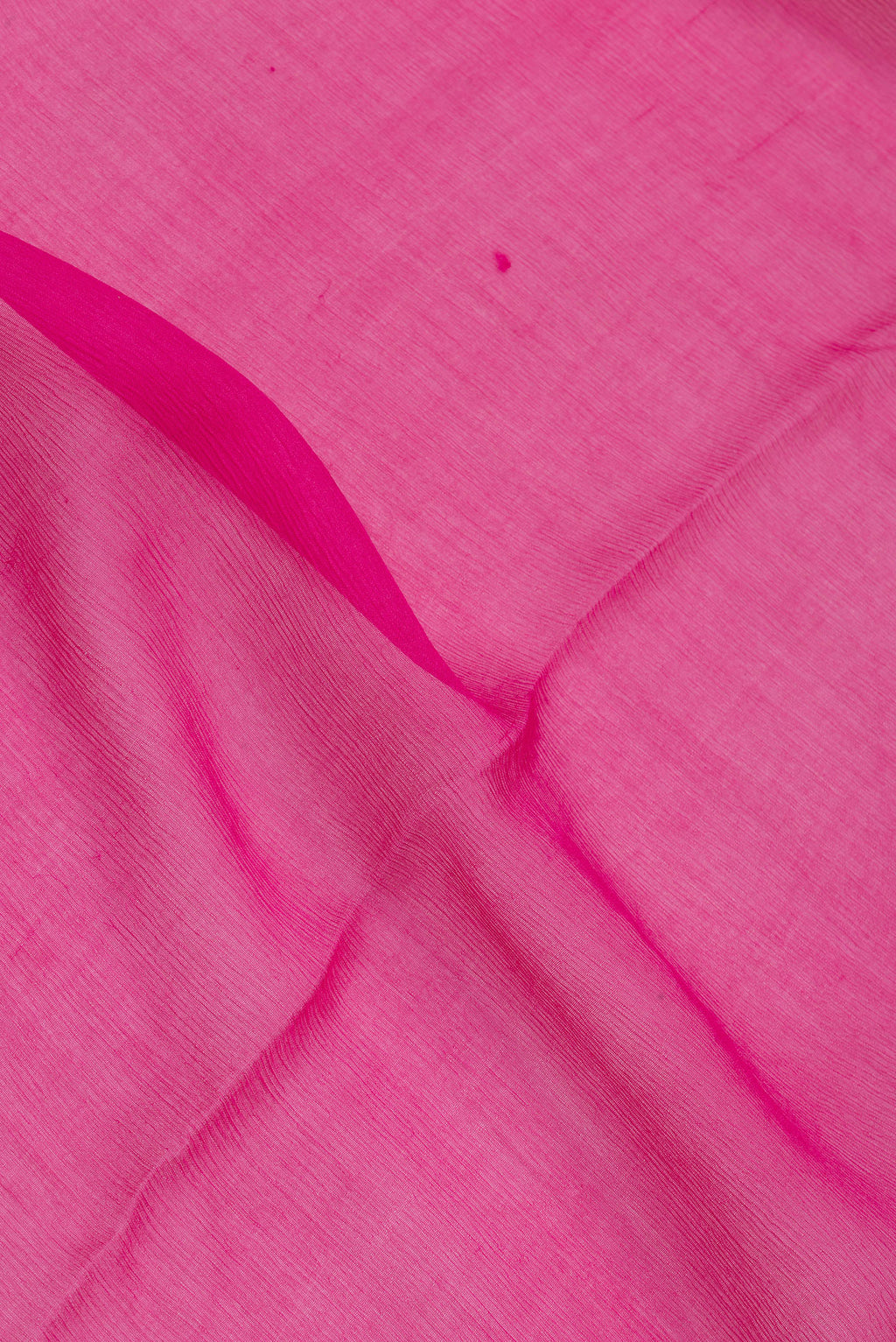 Close up of Dark Pink Mysore Chiffon Saree with Plain Body and Zari Border.  displaying folds