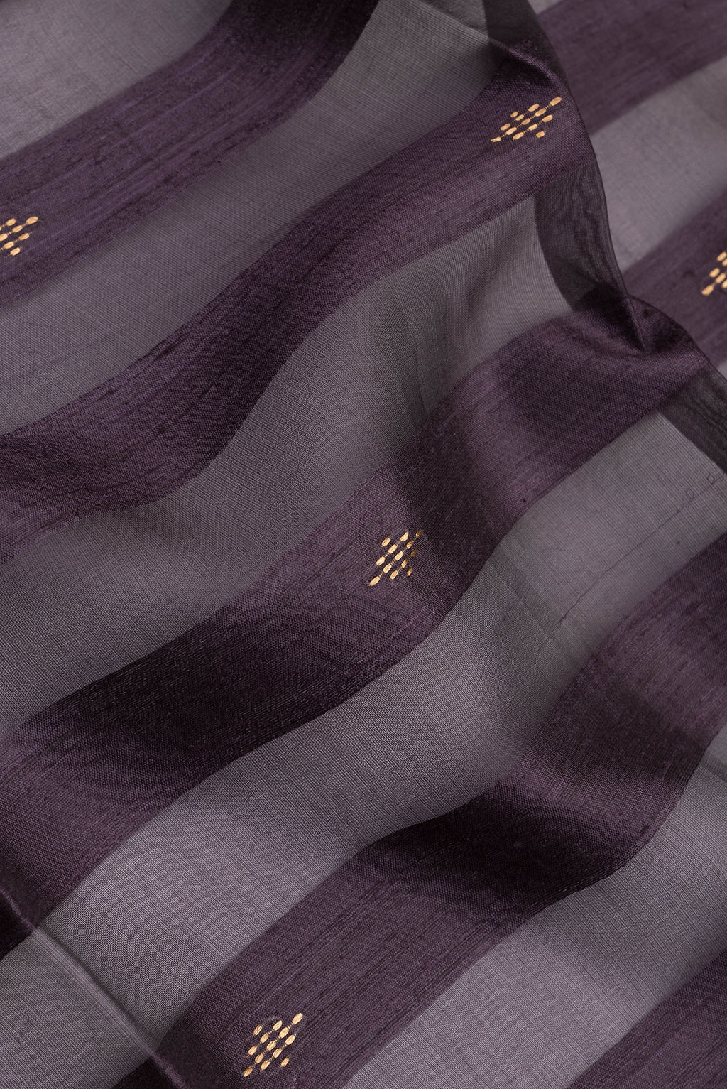 Close up of Burgundy Tussar Silk Saree with Stripes on the body and Zari Border.  displaying folds