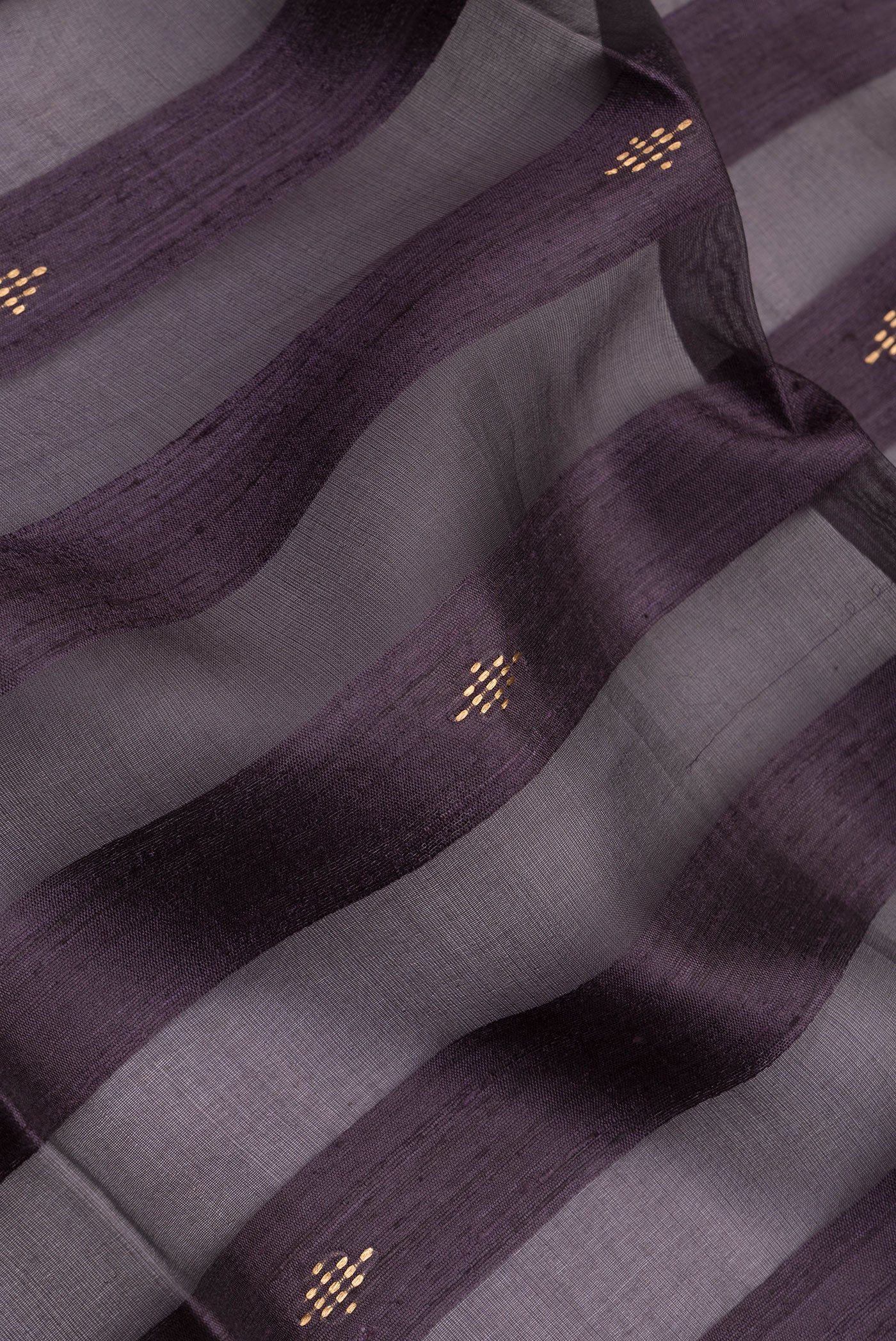 Close up of Burgundy Tussar Silk Saree with Stripes on the body and Zari Border.  displaying folds