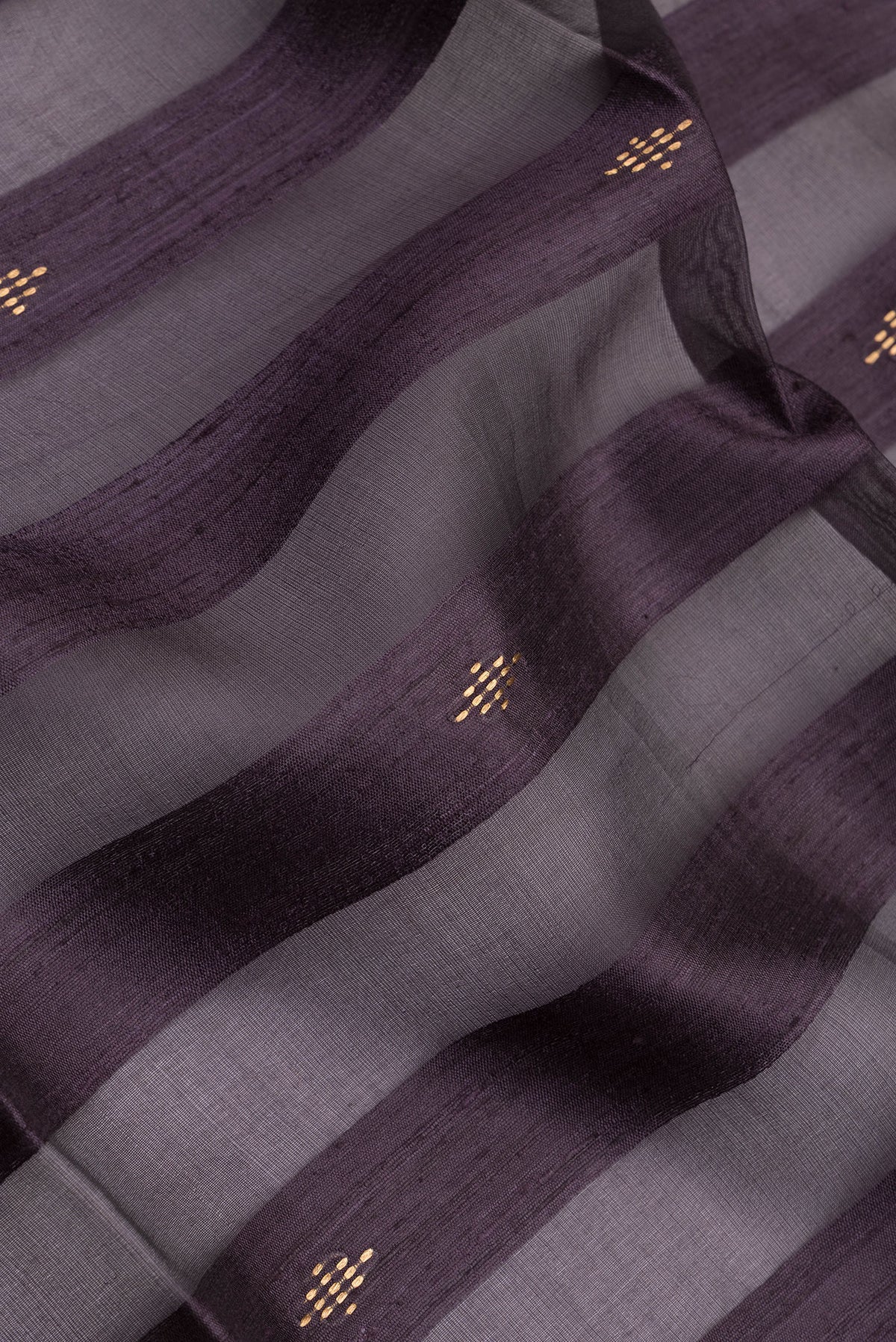 Close up of Burgundy Tussar Silk Saree with Stripes on the body and Zari Border.  displaying folds