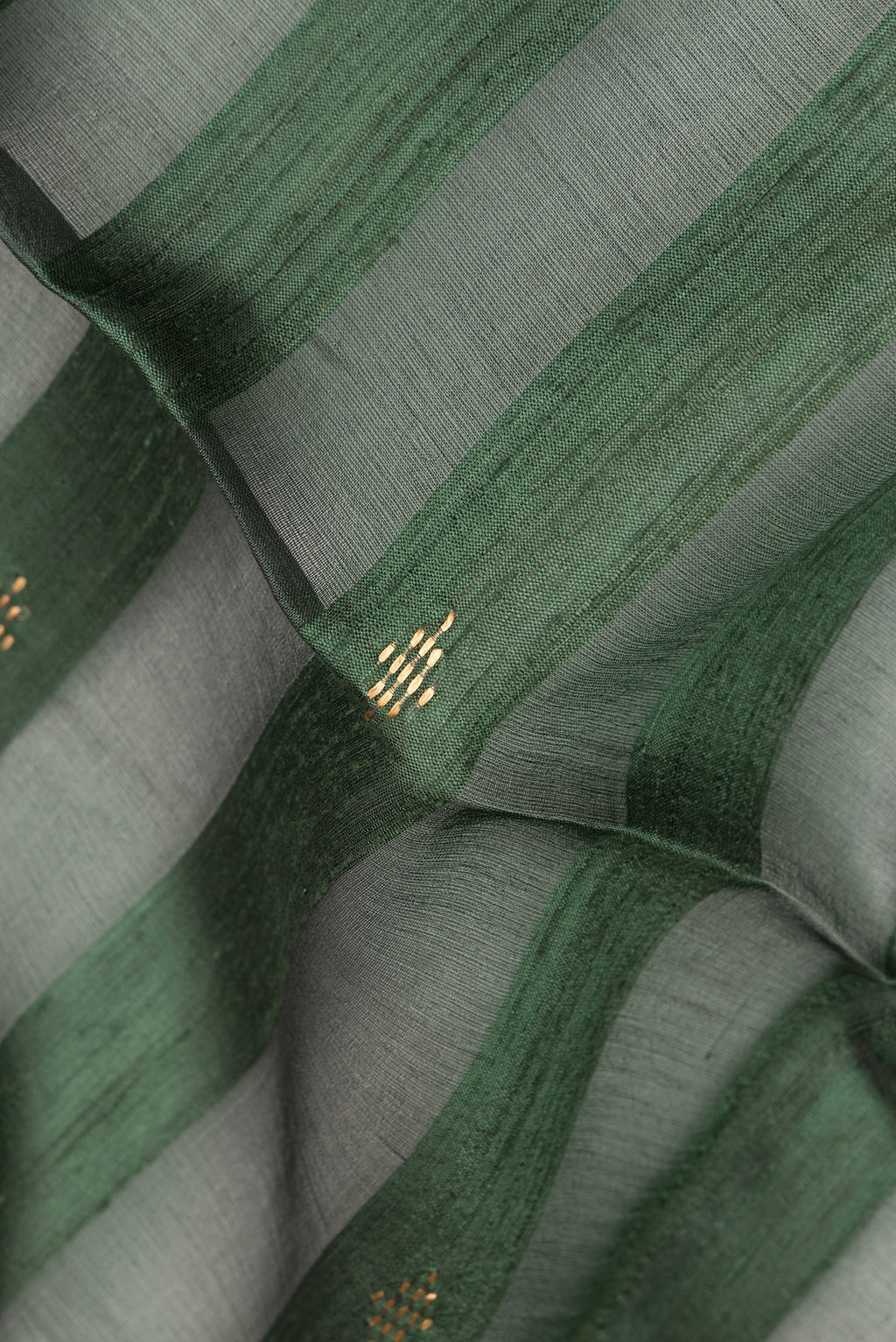 Close up of Olive Green Dual Tone Tussar Saree with Stripes on the body and Zari Border.  displaying folds