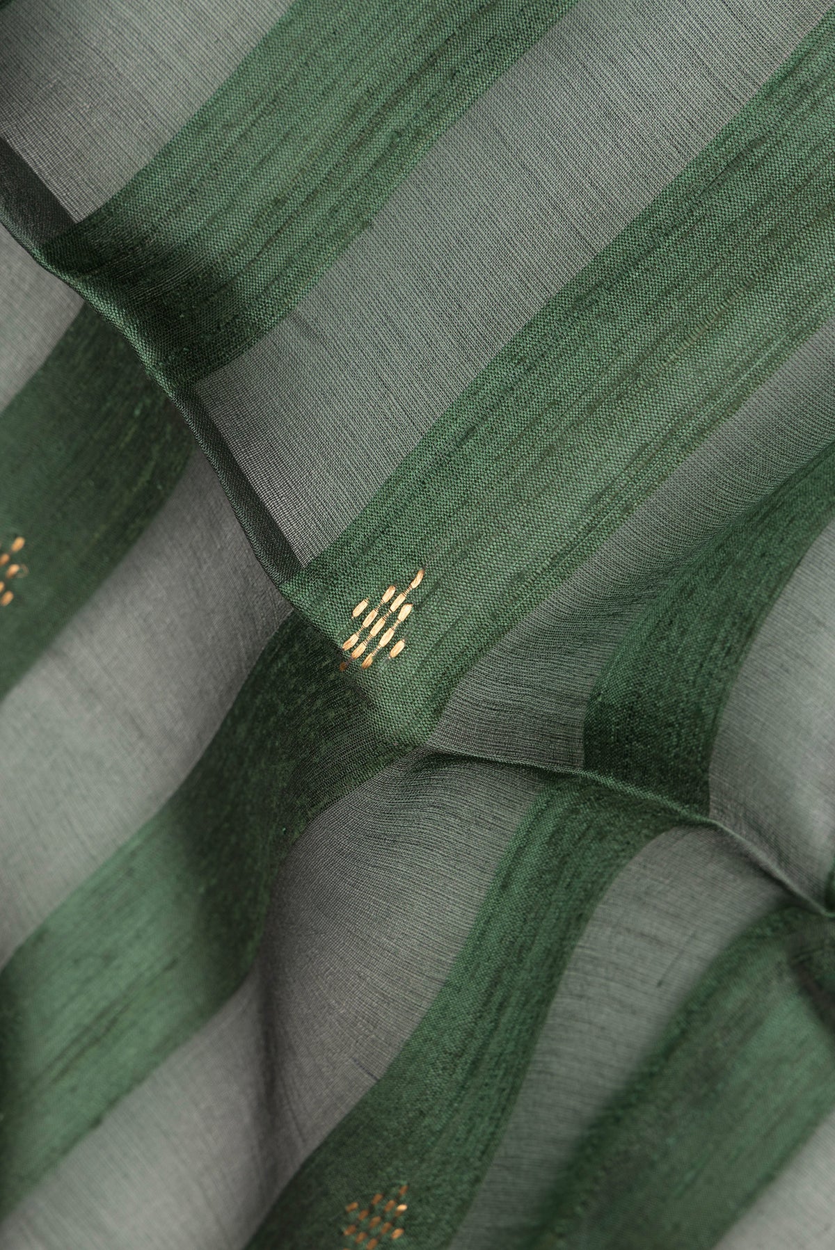 Close up of Olive Green Dual Tone Tussar Saree with Stripes on the body and Zari Border.  displaying folds
