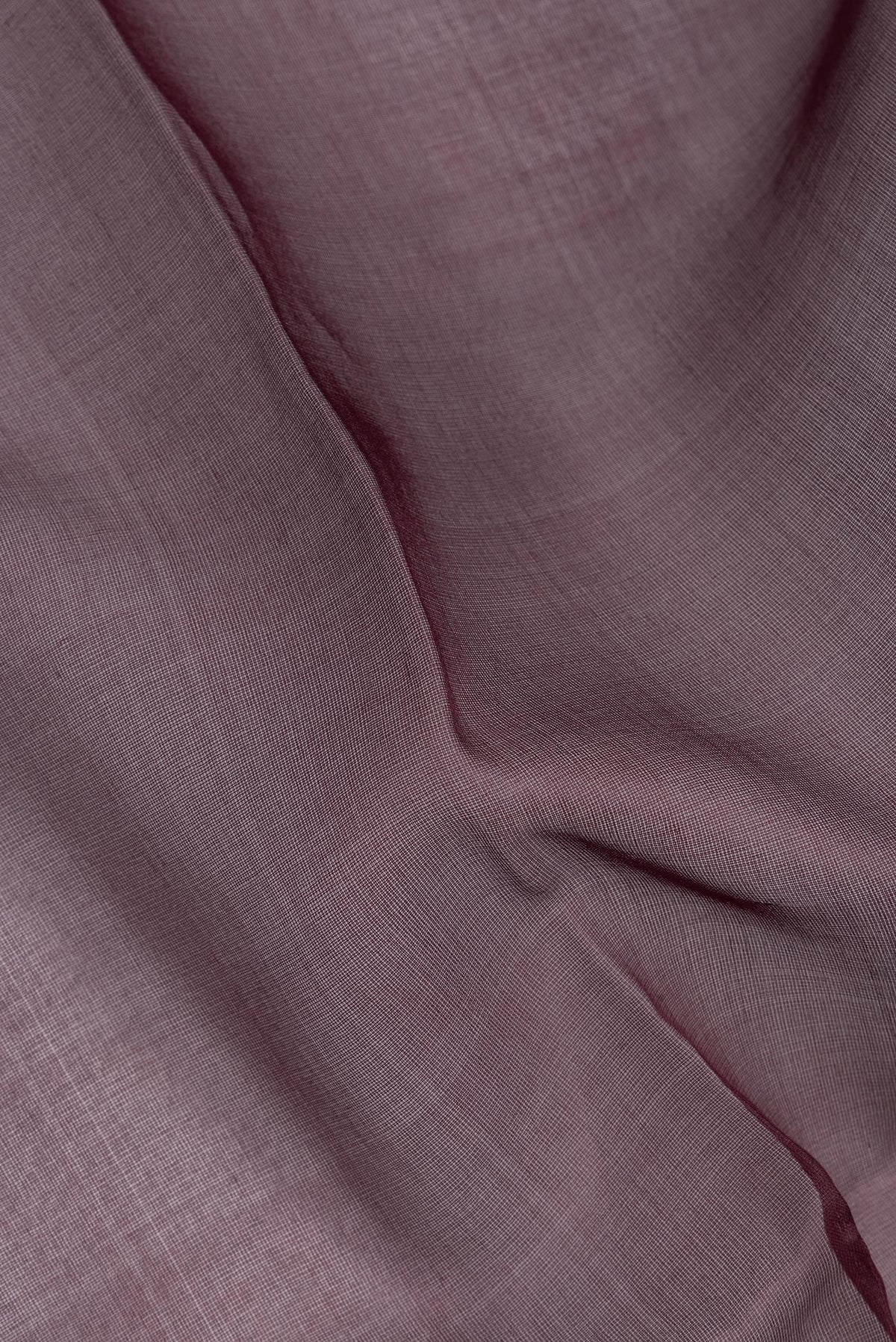 Close up of Pure Silk Burgundy Dual Tone Tussar Saree with Plain Body and Fancy Border.  displaying folds