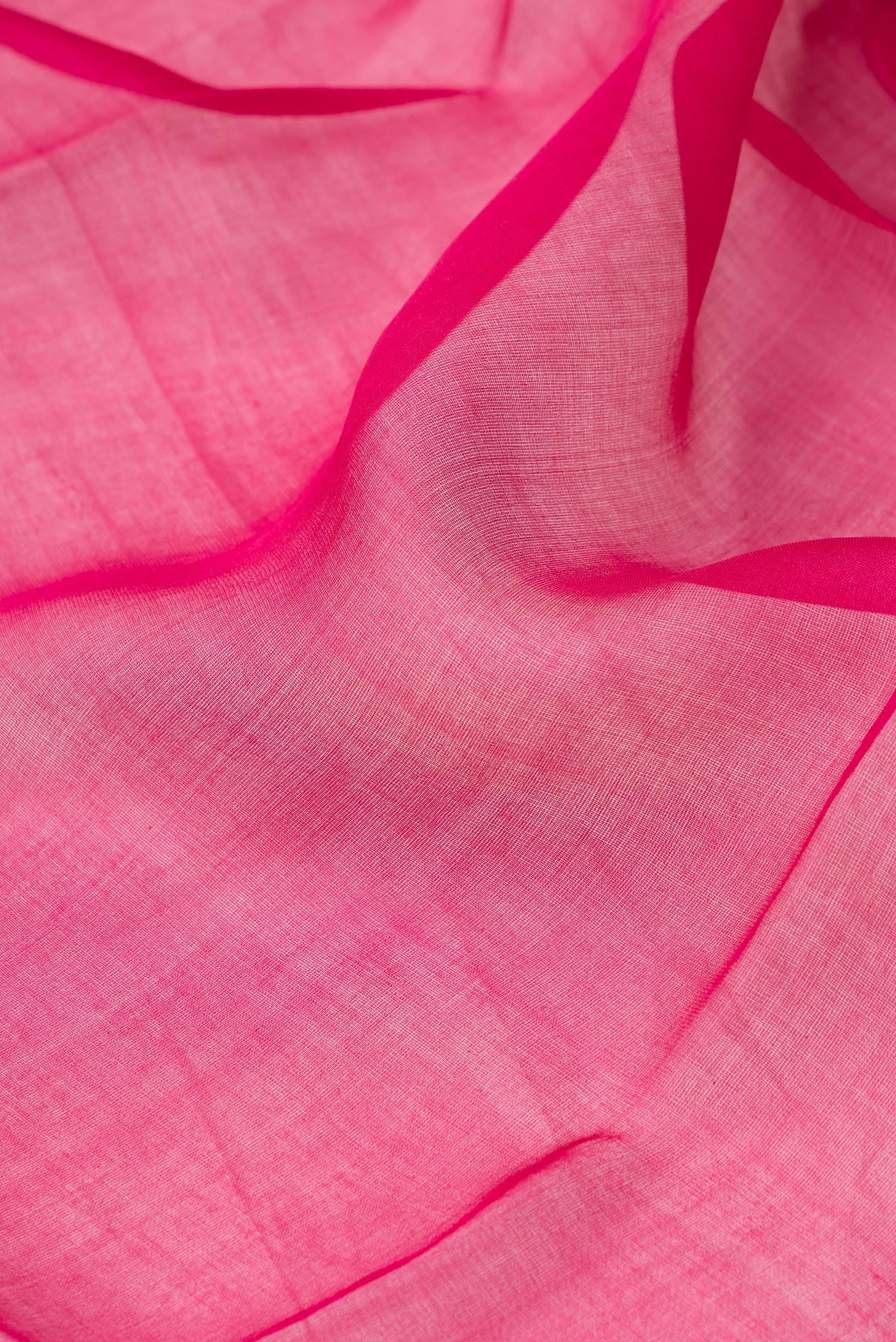 Close up of Dark Pink Organza Silk Saree with Plain Body and Fancy Border.  displaying folds