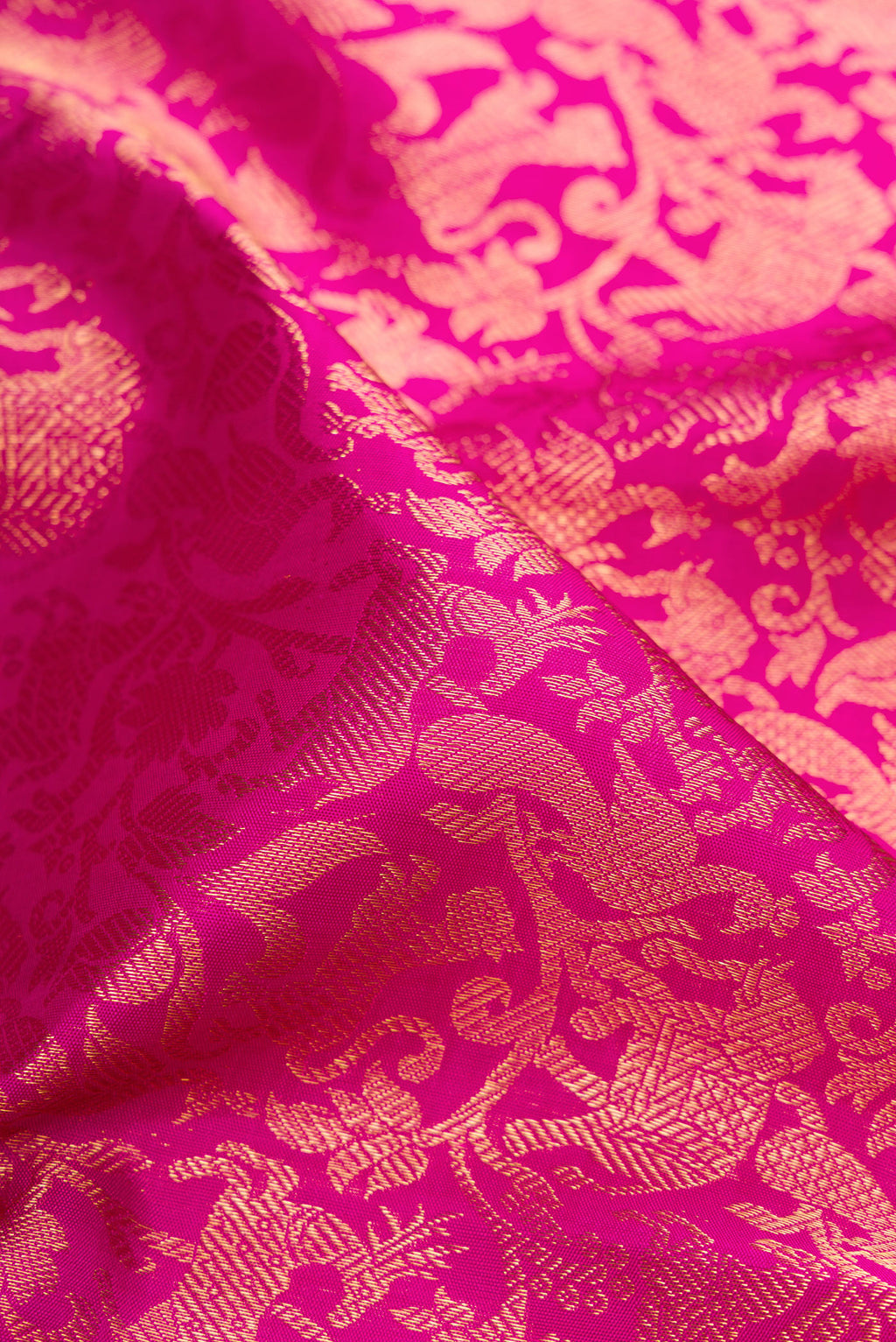 Close up of Magenta Kanjivaram Silk Saree with Zari Brocade on the body and Zari Border.  displaying folds