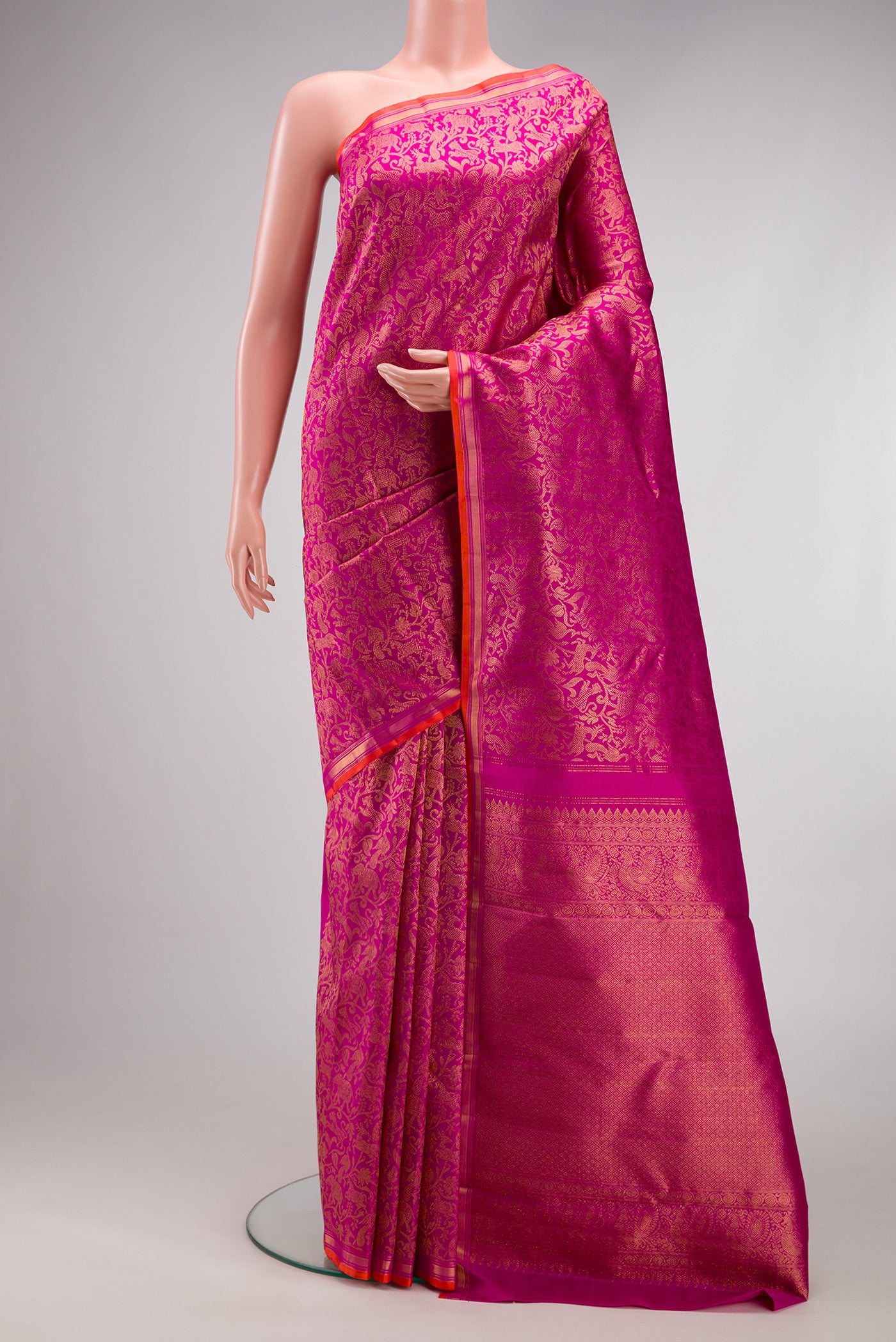 Magenta Kanjivaram Silk Saree with Zari Brocade on the body and Zari Border.  displayed on a mannequin