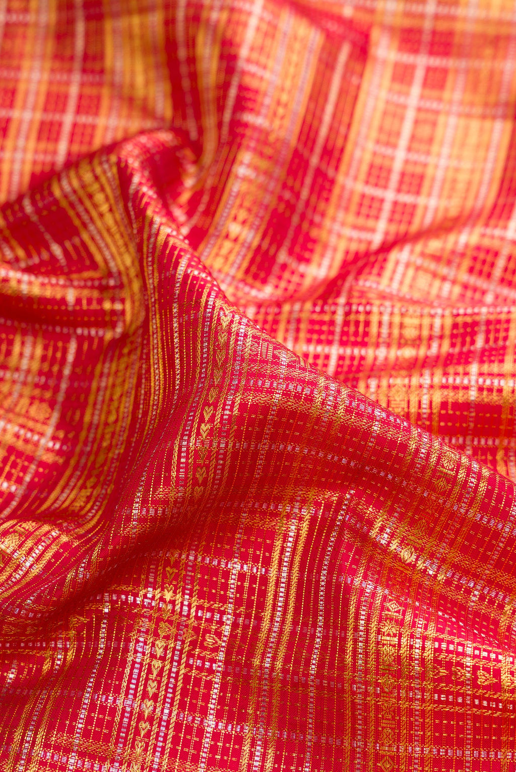 Close up of Pure Silk Red Kanchipuram Saree with Zari Brocade on the body and Fancy Border.  displaying folds
