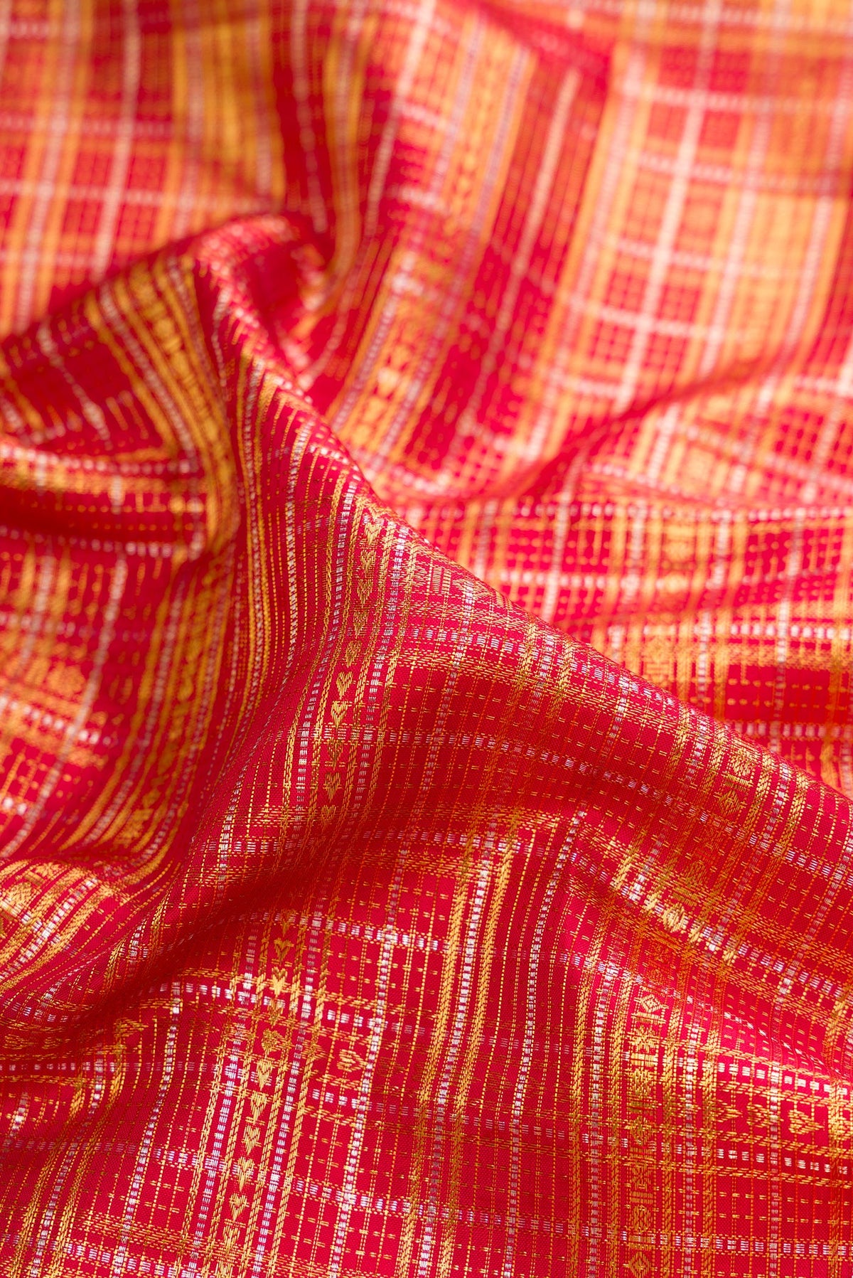 Close up of Pure Silk Red Kanchipuram Saree with Zari Brocade on the body and Fancy Border.  displaying folds