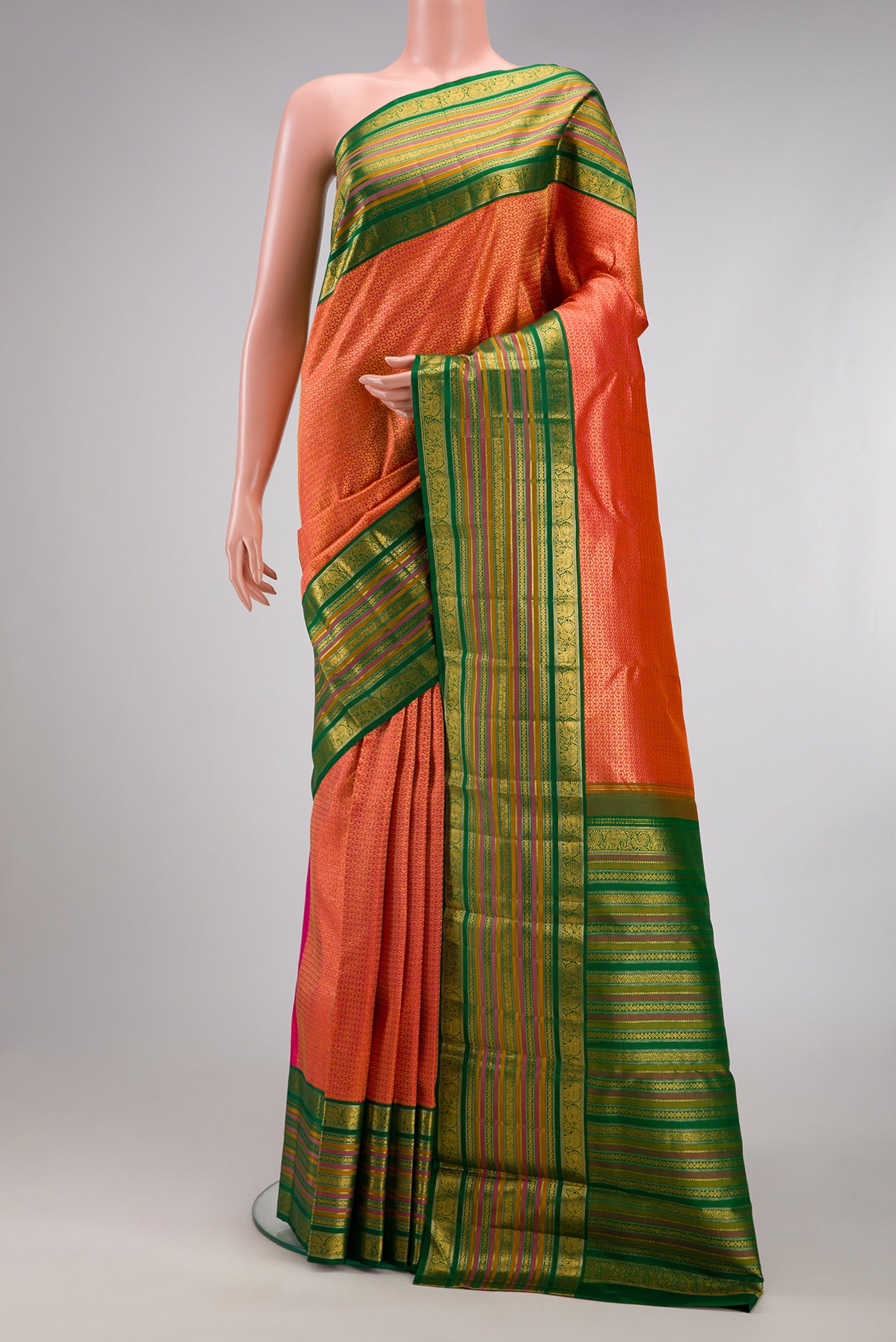 Orange Dual Tone Kanchipuram Silk Saree with Zari Brocade on the body and Zari Border.  displayed on a mannequin