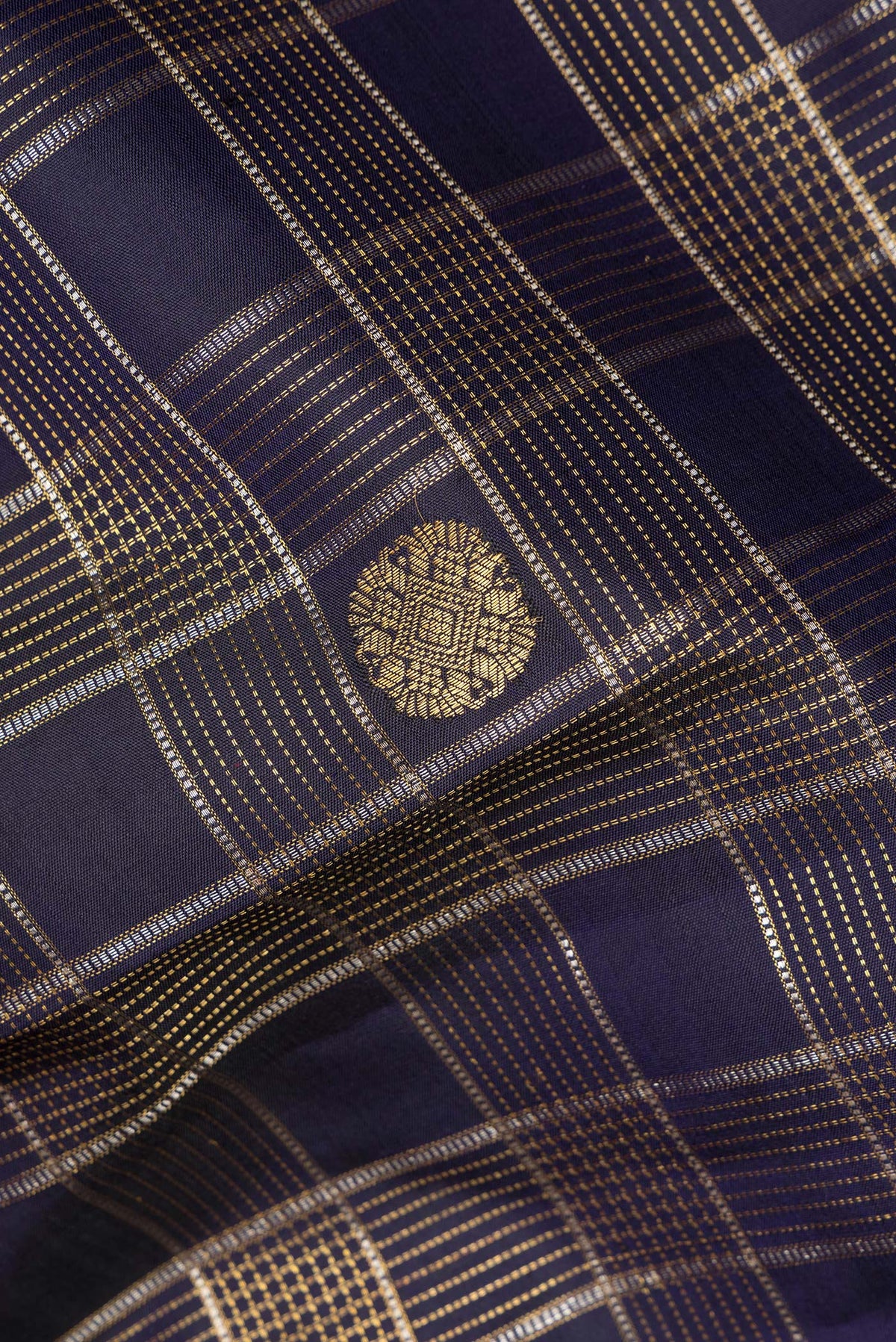 Close up of Pure Silk Navy Blue Kanchipuram Saree with Checked design on the body and Fancy Border.  displaying folds